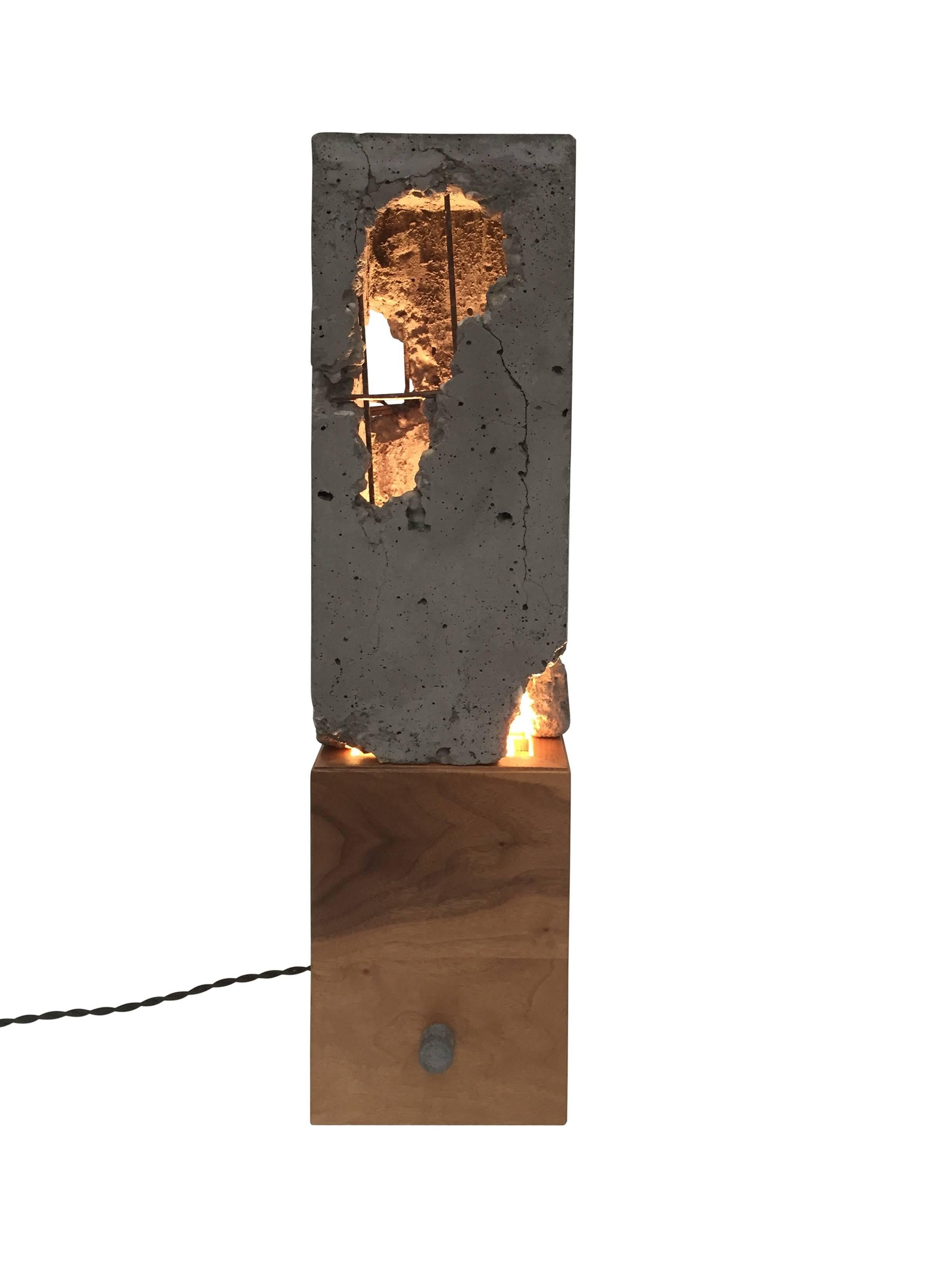 These lights are composed of a solid wood or hand-blackened steel base with a cast-concrete 
