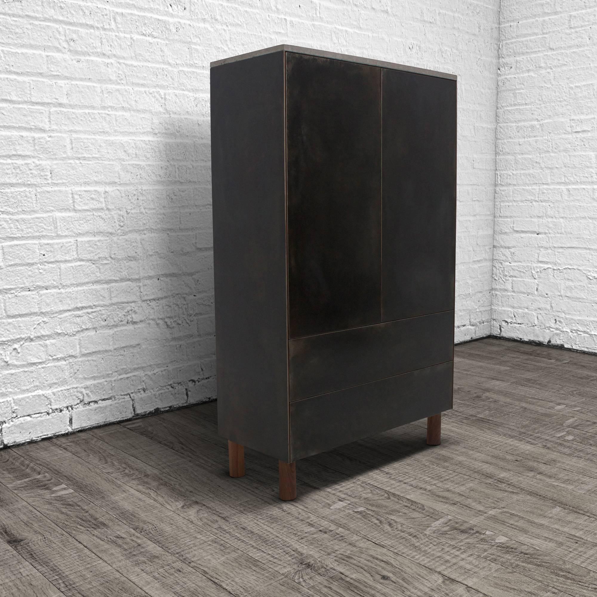 This cabinet combines three elemental materials, concrete, steel and wood to create a grounded, but elegant piece of furniture. The fascia is cold-rolled steel laminated to a walnut veneer core. The cabinet is topped with a cast-concrete slab.