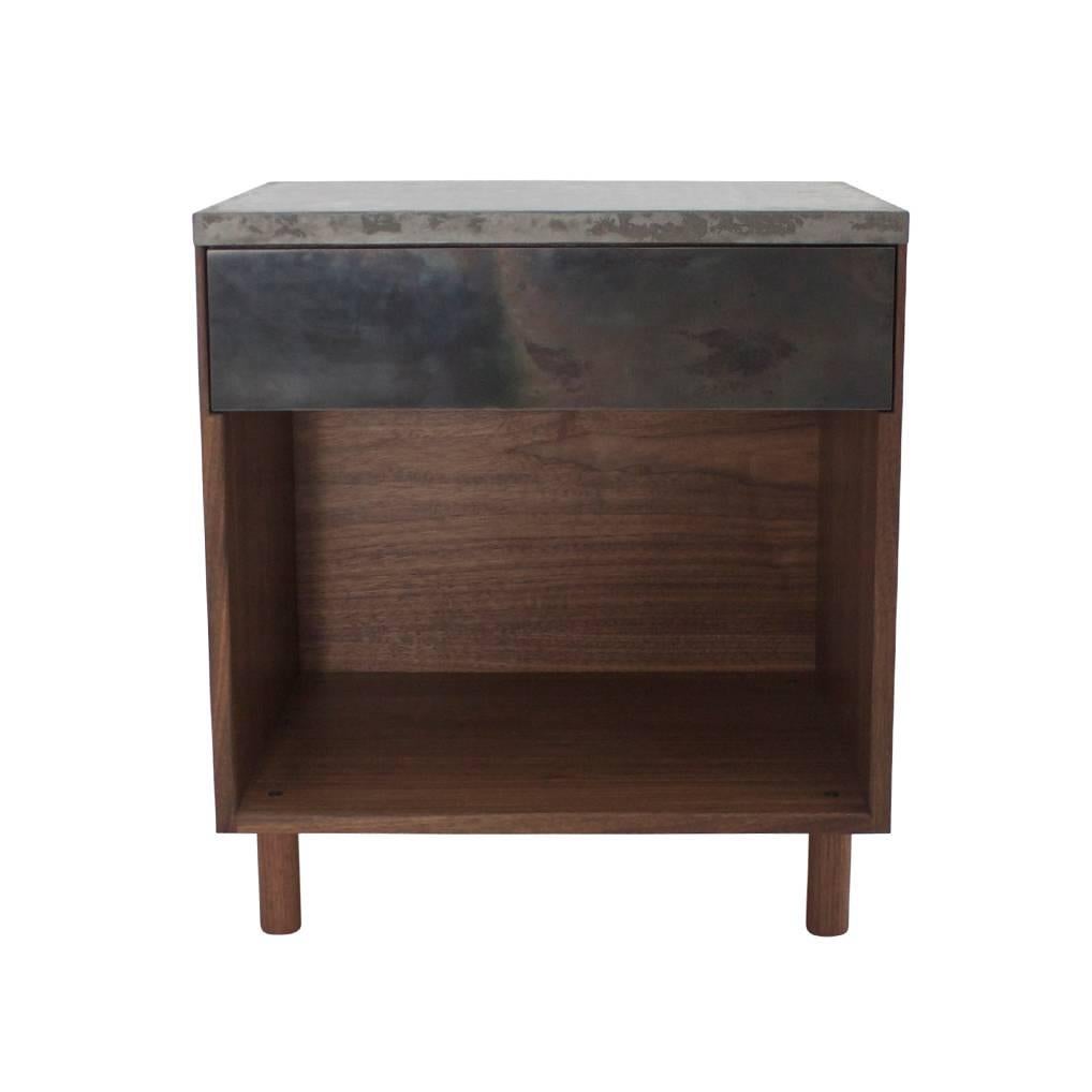 This side table is a smaller version of the "SCW Case." It features one half-blind dovetailed walnut drawer, a cast-concrete top and hand-turned walnut legs. The fascia is cold-rolled steel laminated to a walnut veneer core. Rurak