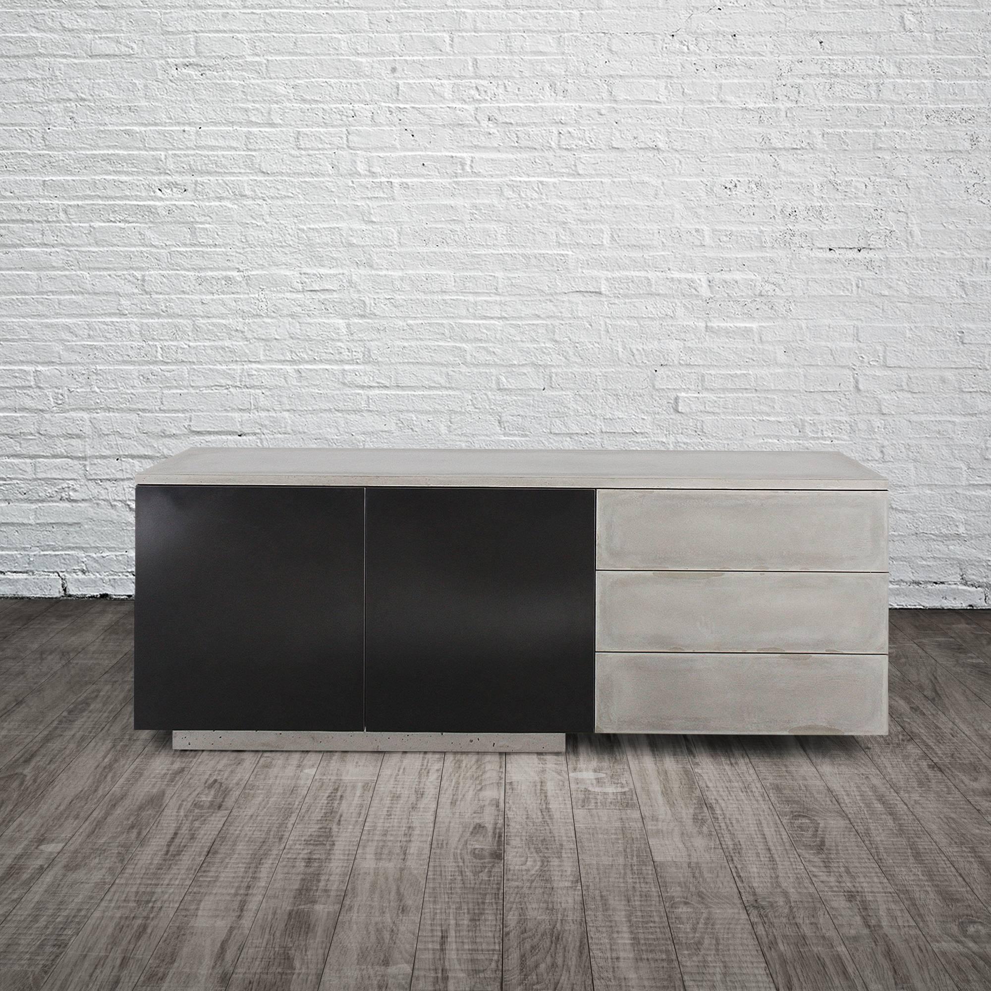 C-210 seamlessly integrates three elemental materials, concrete, steel and wood. The counter-top as well as the drawer faces are all cast concrete. The piece is fully wrapped and fully finished (front and back) with hand-blackened steel that is