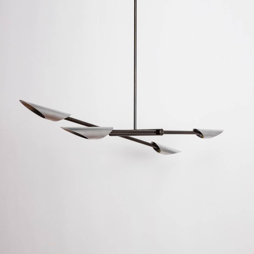 A statement piece that expresses balance and symmetry through its cantilevered form and handcrafted finishes.