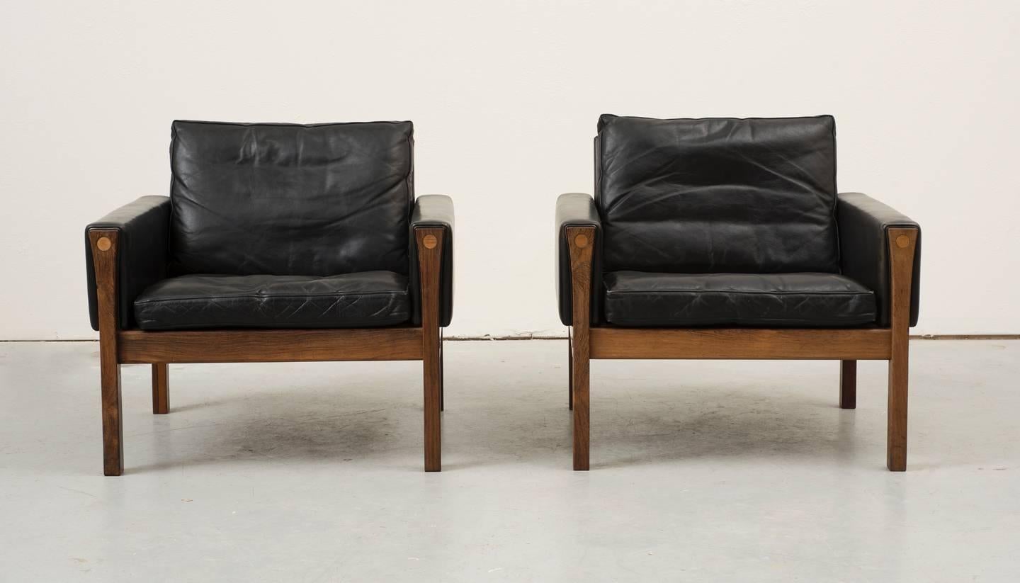 Rare pair of elegant rosewood and black leather chairs designed by Hans Wegner. These examples in beautiful shape with original, supple leather. Designed in 1962 for AP Stolen.