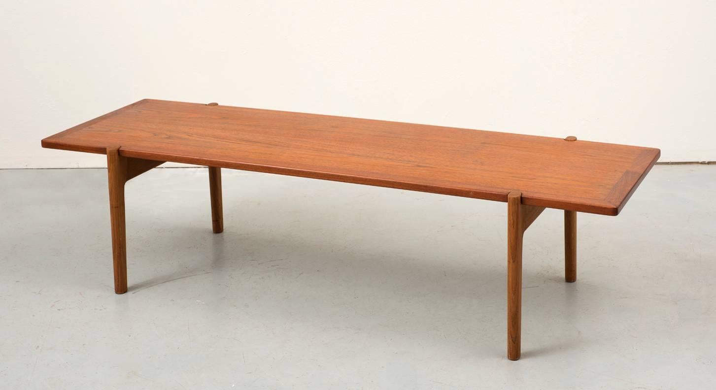 Large coffee table by Hans Wegner with reversible teak top and oak frame. Top reverses to black laminate set in a teak frame. Manufactured by Johannes Hansen, circa 1950s.