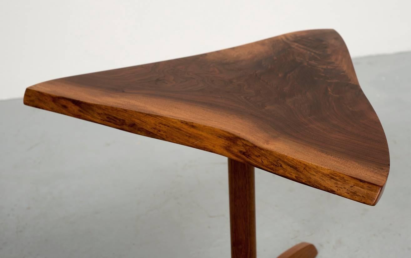 Black walnut triangular side table by George Nakashima. Beautiful color and grain pattern. Rare tripod base. Signed and dated May 1977.
