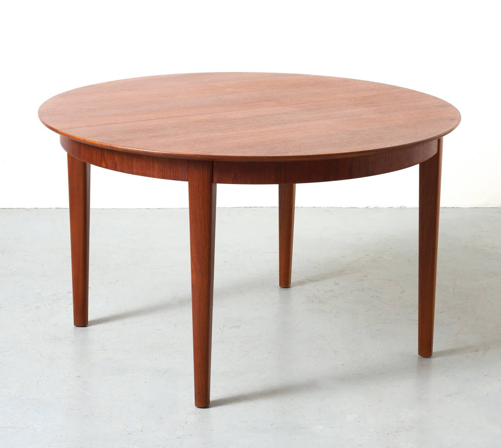 A Henning Kjaernulf teak dining table for Soro Stolefabrik.

Four additional leaves measuring 19.75 inches each. The table extends to 128 inches when fully extended.