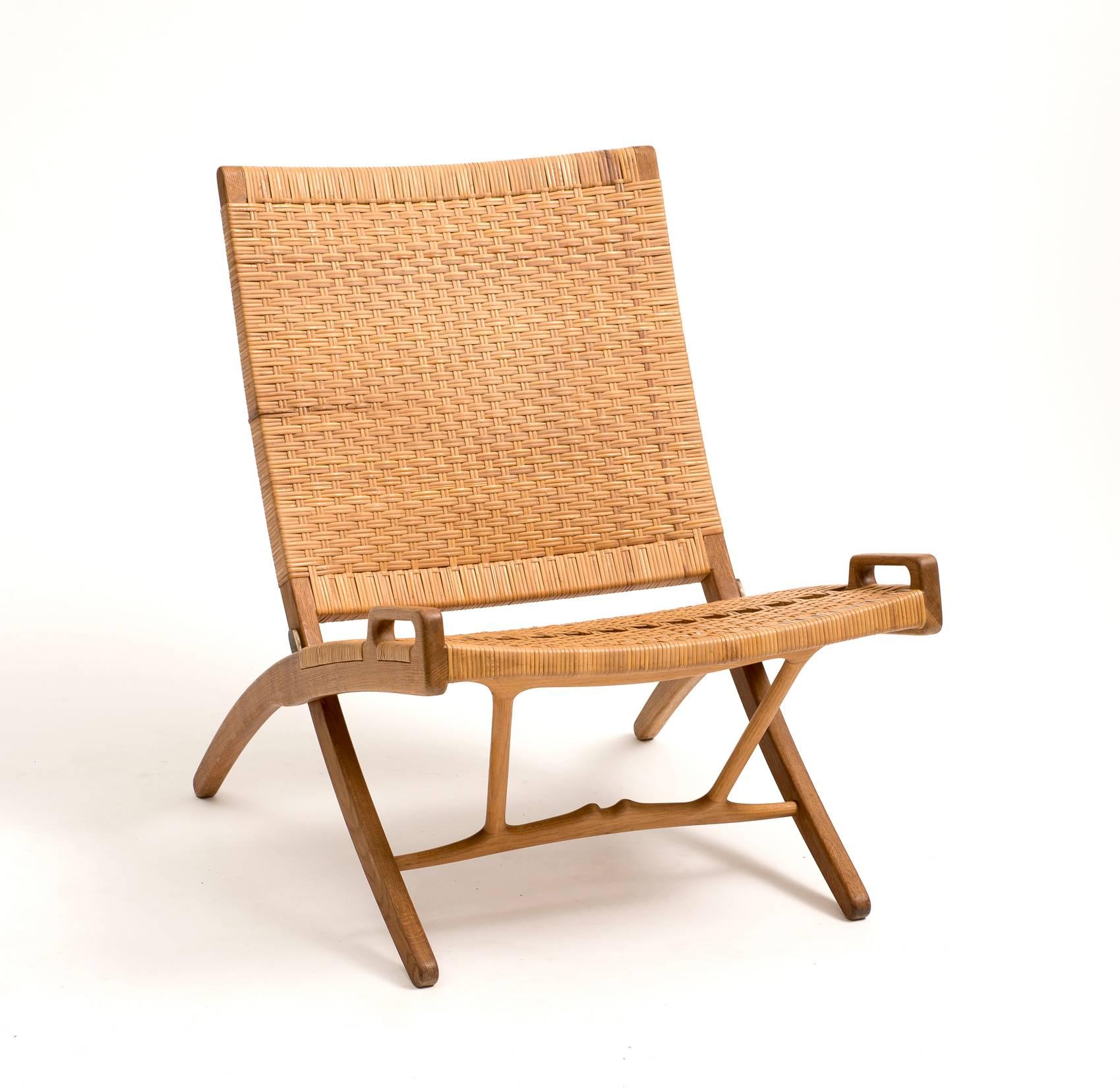 Rare folding chair by Hans Wegner for Johannes Hansen in cane and oak, model JH512, Denmark, 1950s.