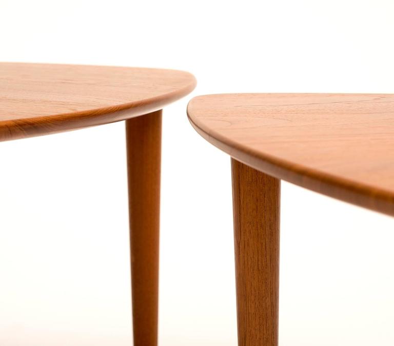 A pair of guitar pick tables in teak with elegant lines, produced by DUX, Sweden, 1960s.