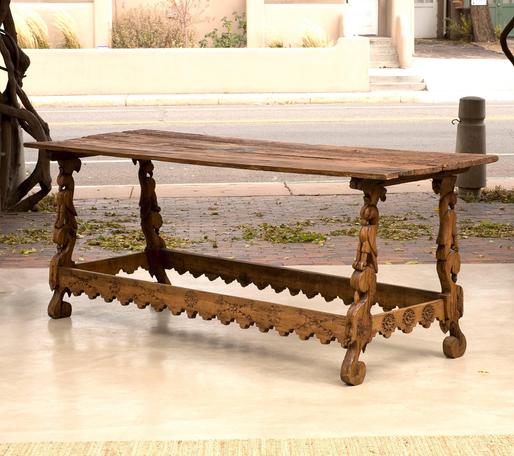 A stunning Spanish Colonial stretcher base table from Mexico in pine with beautiful carved falcon legs, early 18th century.
 