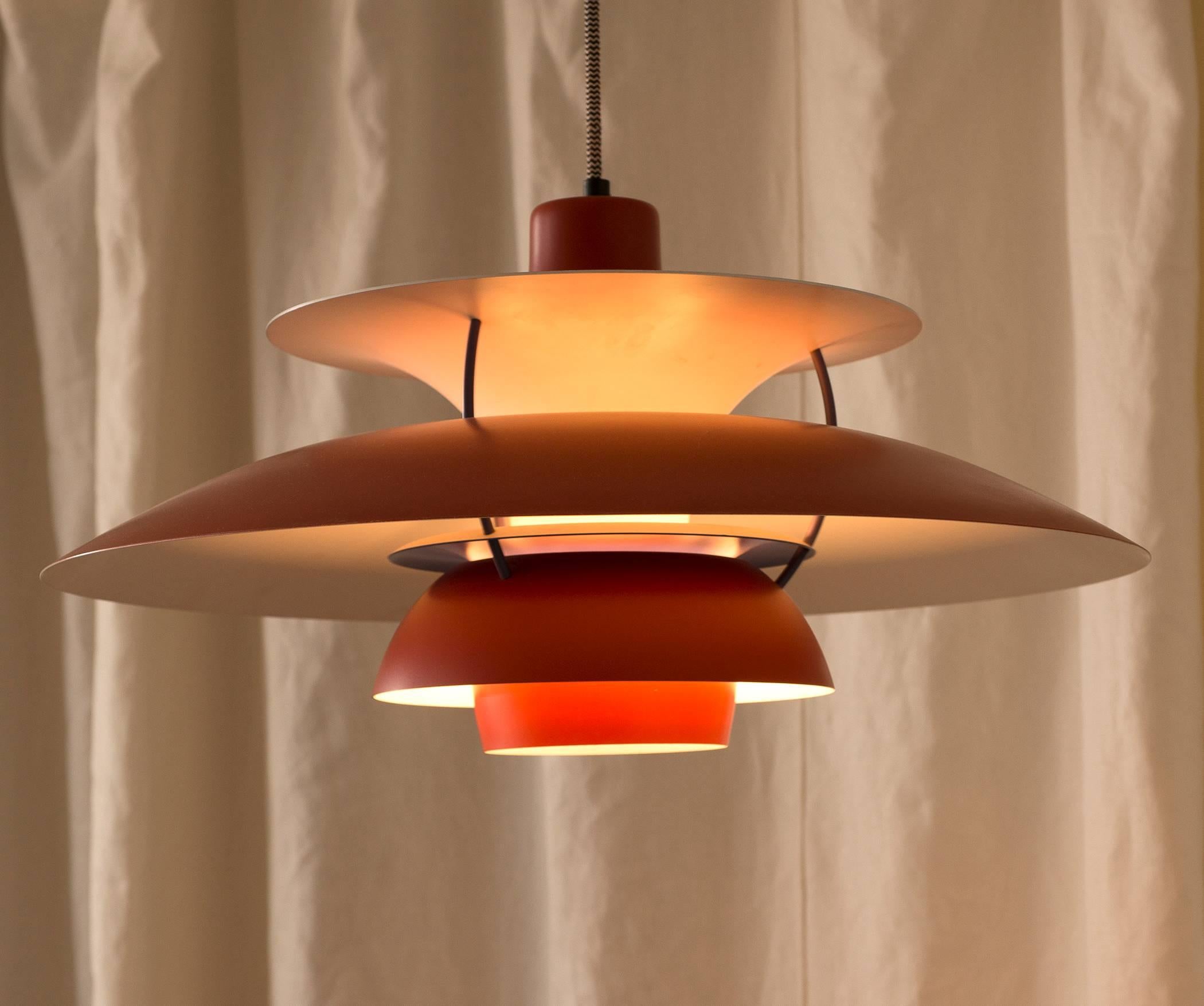A lamp, model PH5 in red, designed by Poul Henningsen for Louis Poulsen, 1958.

We have a number of examples of this model available in red, white and blue.