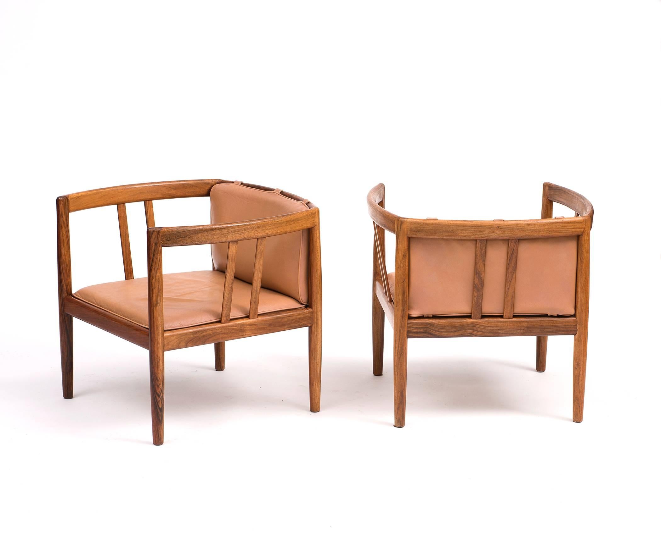 A rare pair of rosewood and leather lounge chairs by Illum Wikkelso for Holger Christiansen, 1960s. Gorgeous rosewood grain with perfectly patinated leather cushions.