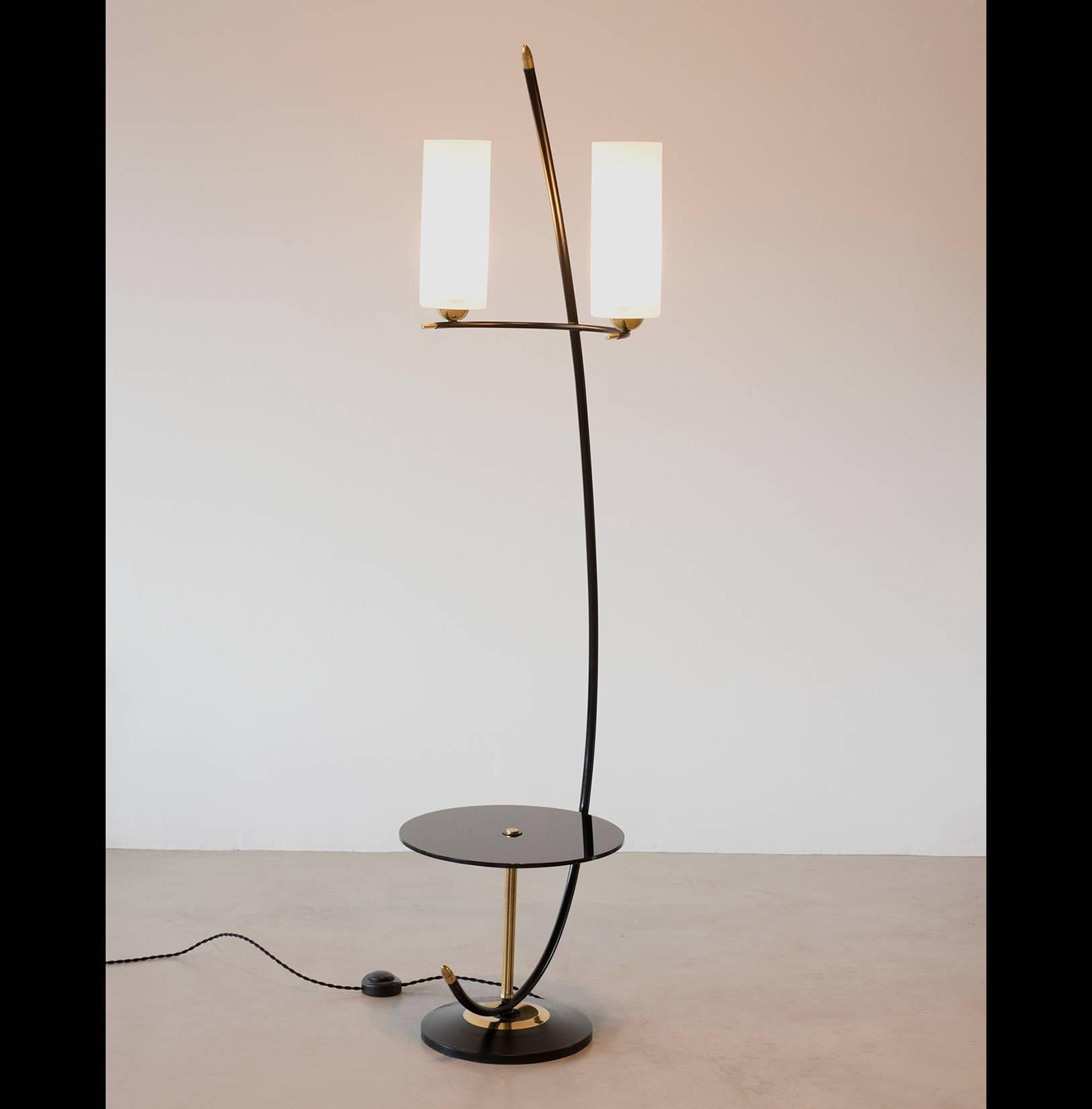 A French floor lamp with black lacquered stem and base, brass accents and a black glass table. The glass diffusers are etched with an organic pattern, circa 1950s.