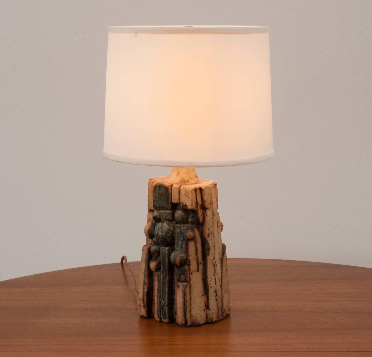 Sculptural, organic ceramic table lamp by Bernard Rooke with green and tan glaze. Signed 
