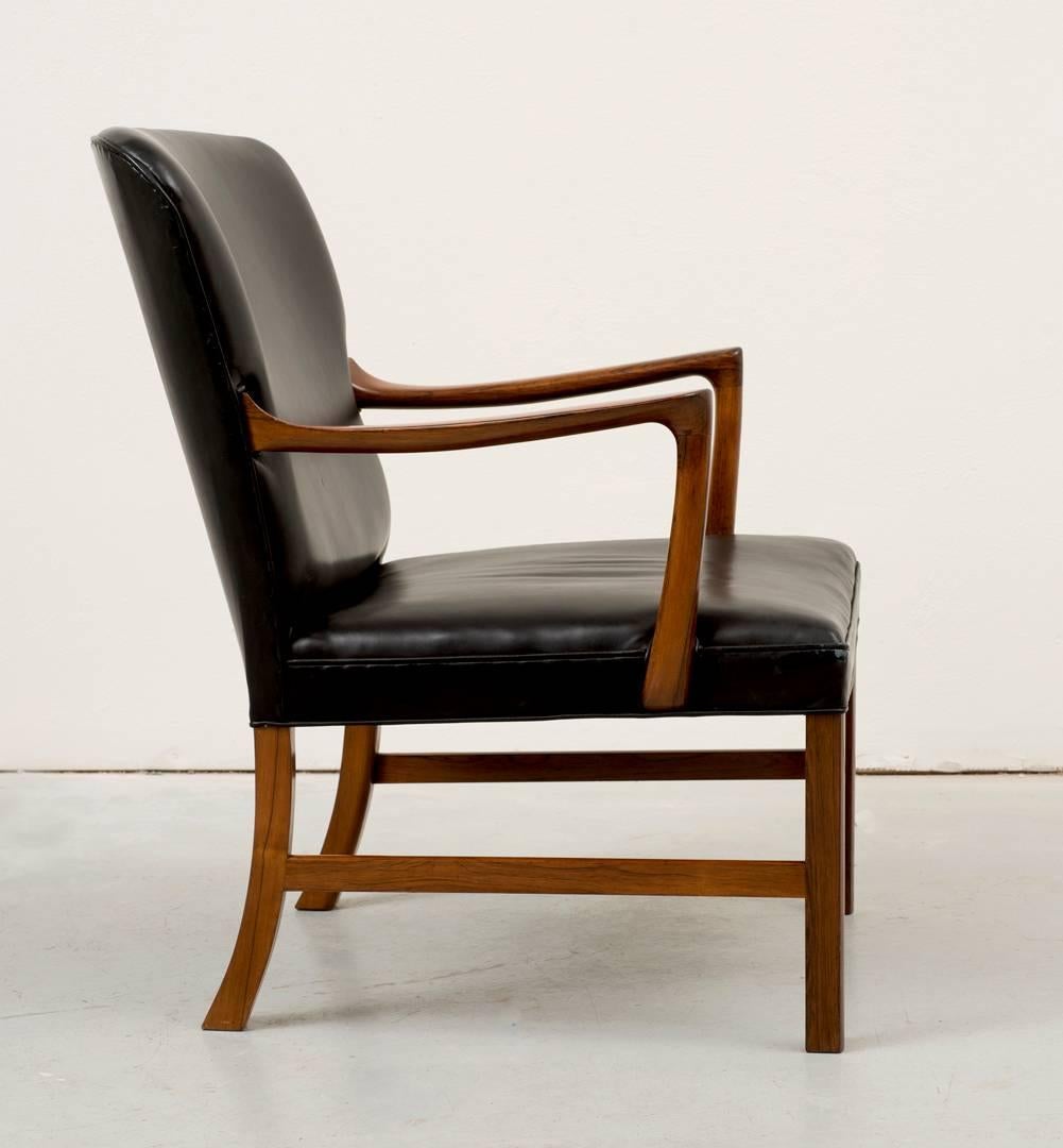 Rare model Ole Wanscher rosewood armchair for A. J. Iversen. Regal lines with pristine vintage black leather, Denmark, 1960s.