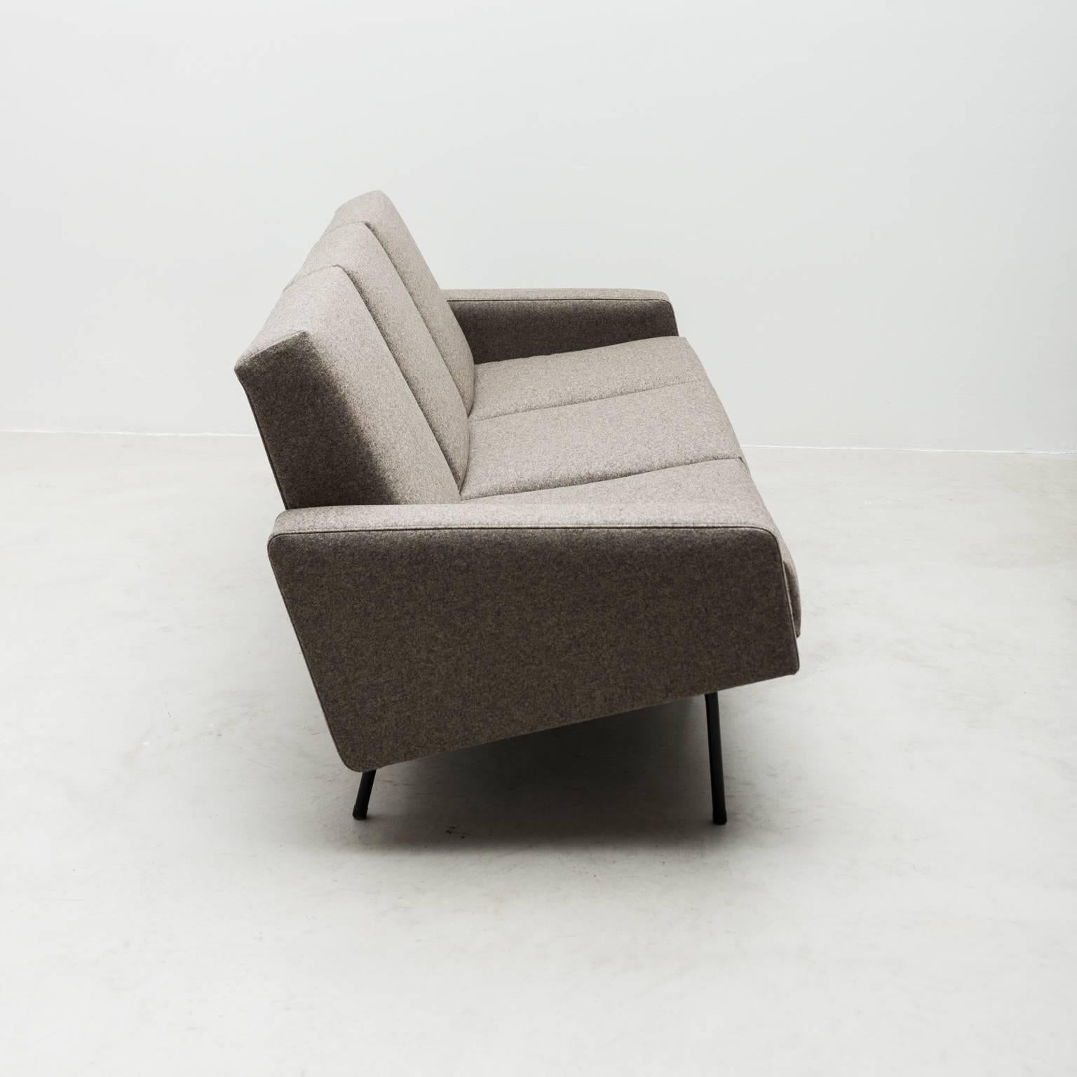A three-seat sofa by Pierre Guariche for Airborne. Frame in black enameled steel. Newly restored in a taupe grey Danish wool by Kvadrat, France, 1950s.