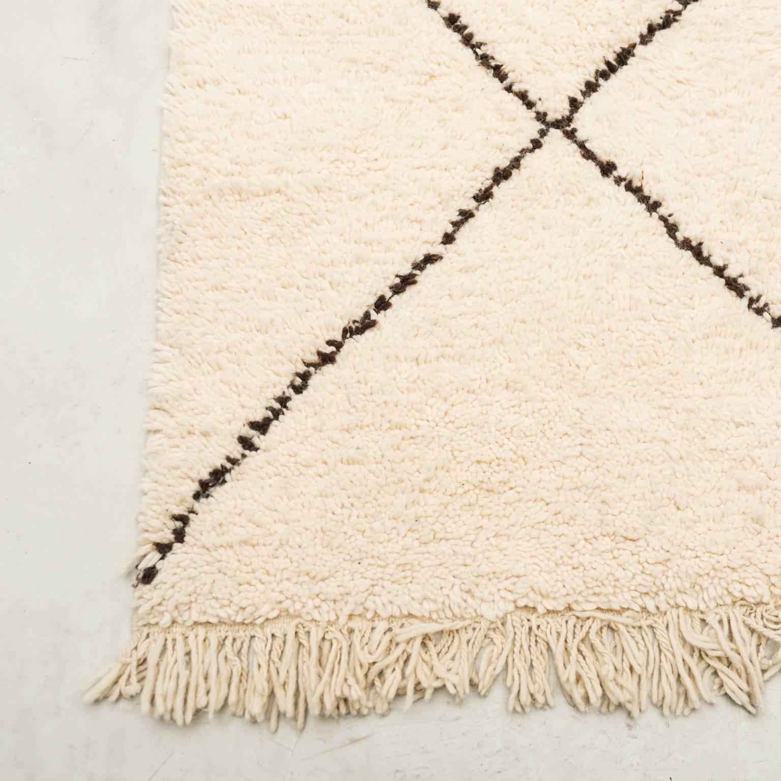 Hand-knotted with undyed natural shades of hand-spun sheep's wool creating a thick, shaggy, lustrous pile.