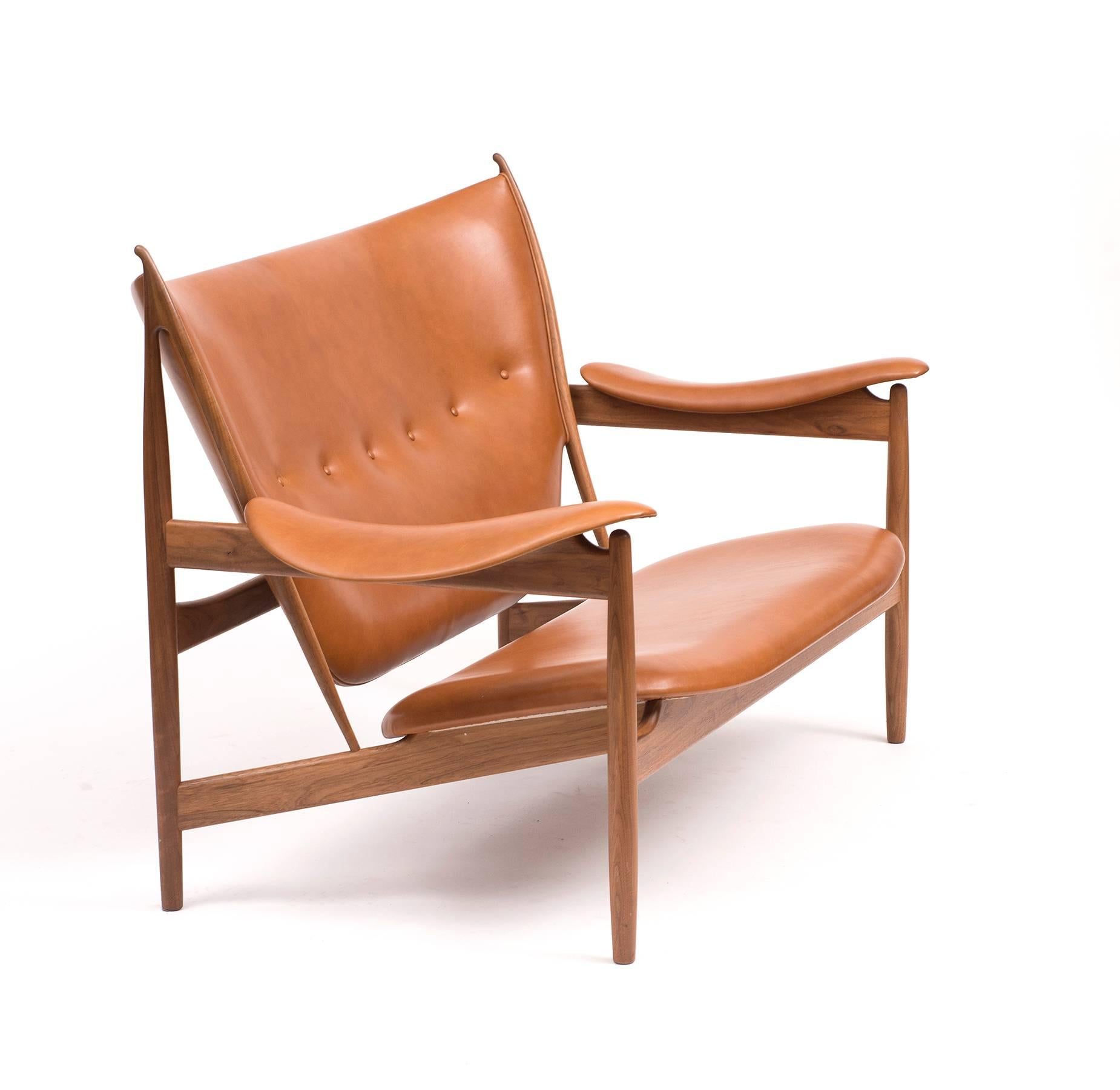 Chieftain sofa by Finn Juhl. Two-seat sofa with frame of walnut. Seat, back and armrests upholstered with brown leather. Designed in 1949 by Finn Juhl and originally only produced in one single issue by Niels Vodder. Reintroduced in 2013 by
