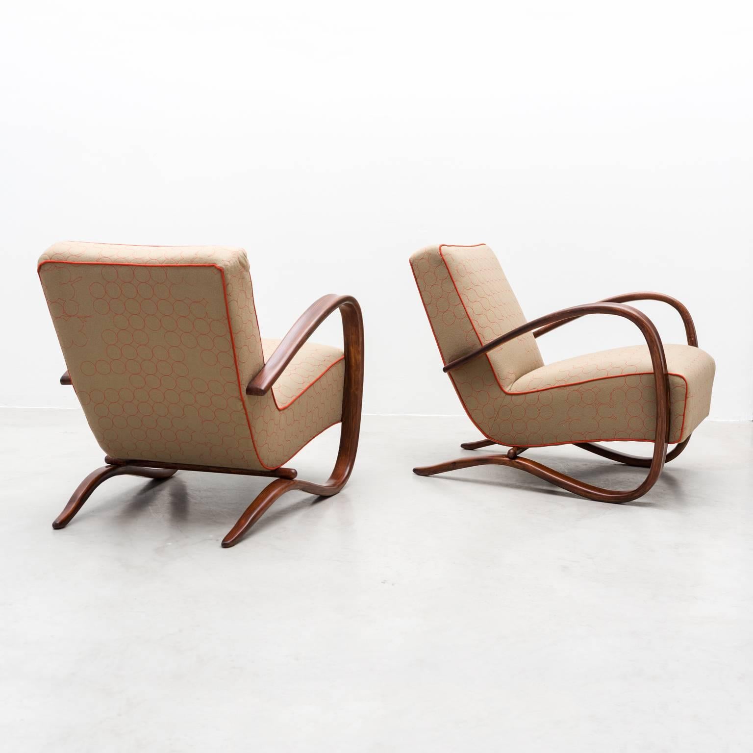 A stunning pair of model H269 chairs by Jindrich Halabala. These chairs retain their original patina on the beech arms, which has been enhanced by a French polish technique. They have been stripped to their seagrass and springs and reupholstered in