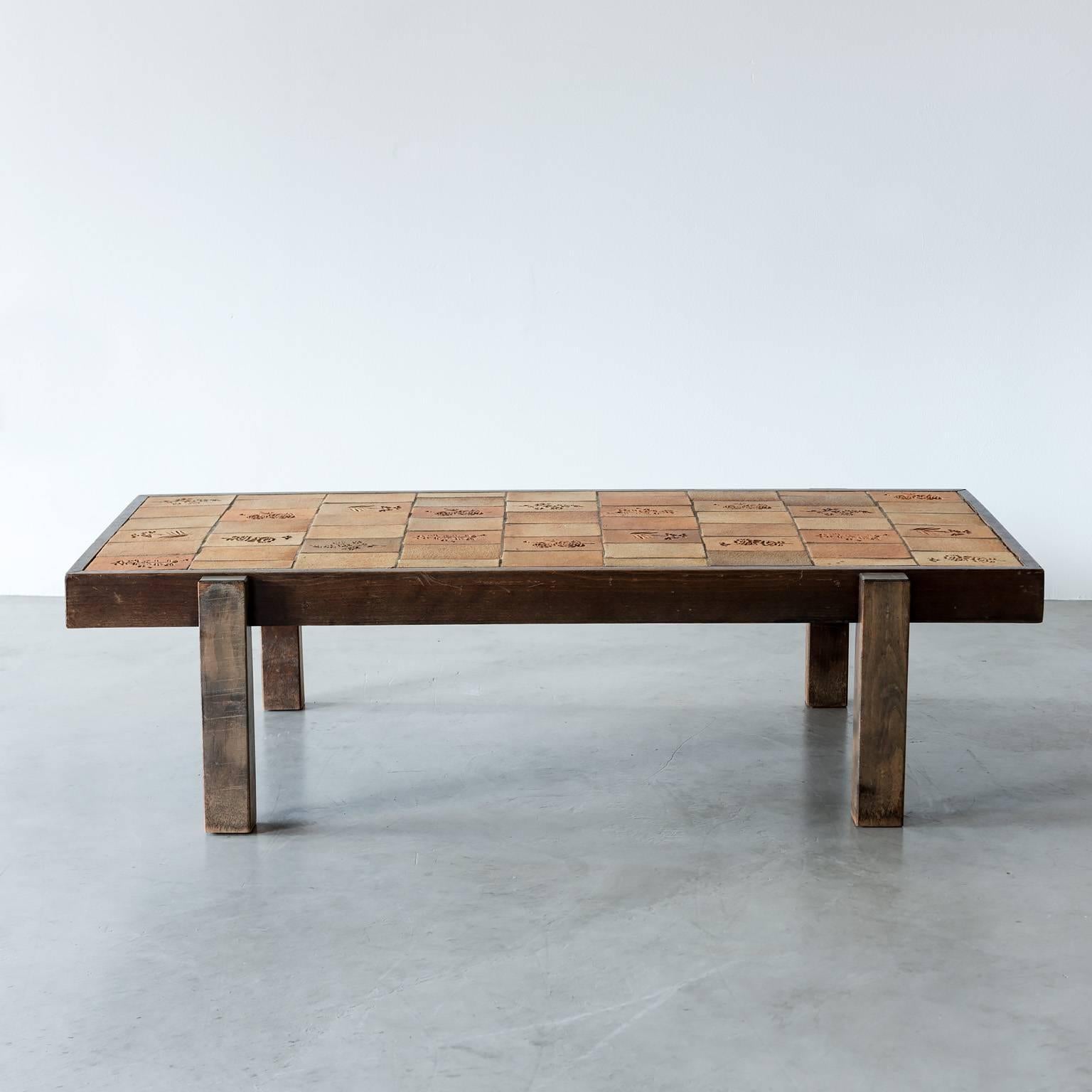 Coffee table in oak and ceramic tile by Roger Capron. Capron created these tiles by pressing garrigue, or the low-growing vegetation on the limestone hills of the Mediterranean coast, into the tiles before firing them. From Vallauris, France, 1970s.