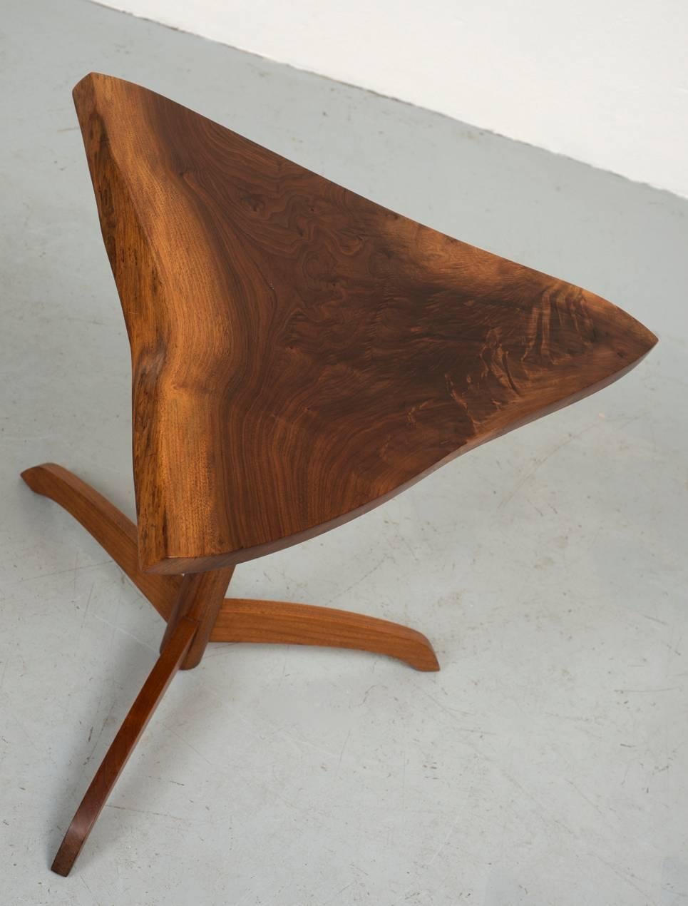 Black walnut triangular side table by George Nakashima. Beautiful color and grain pattern. Rare tripod base. Signed and dated May 1977.