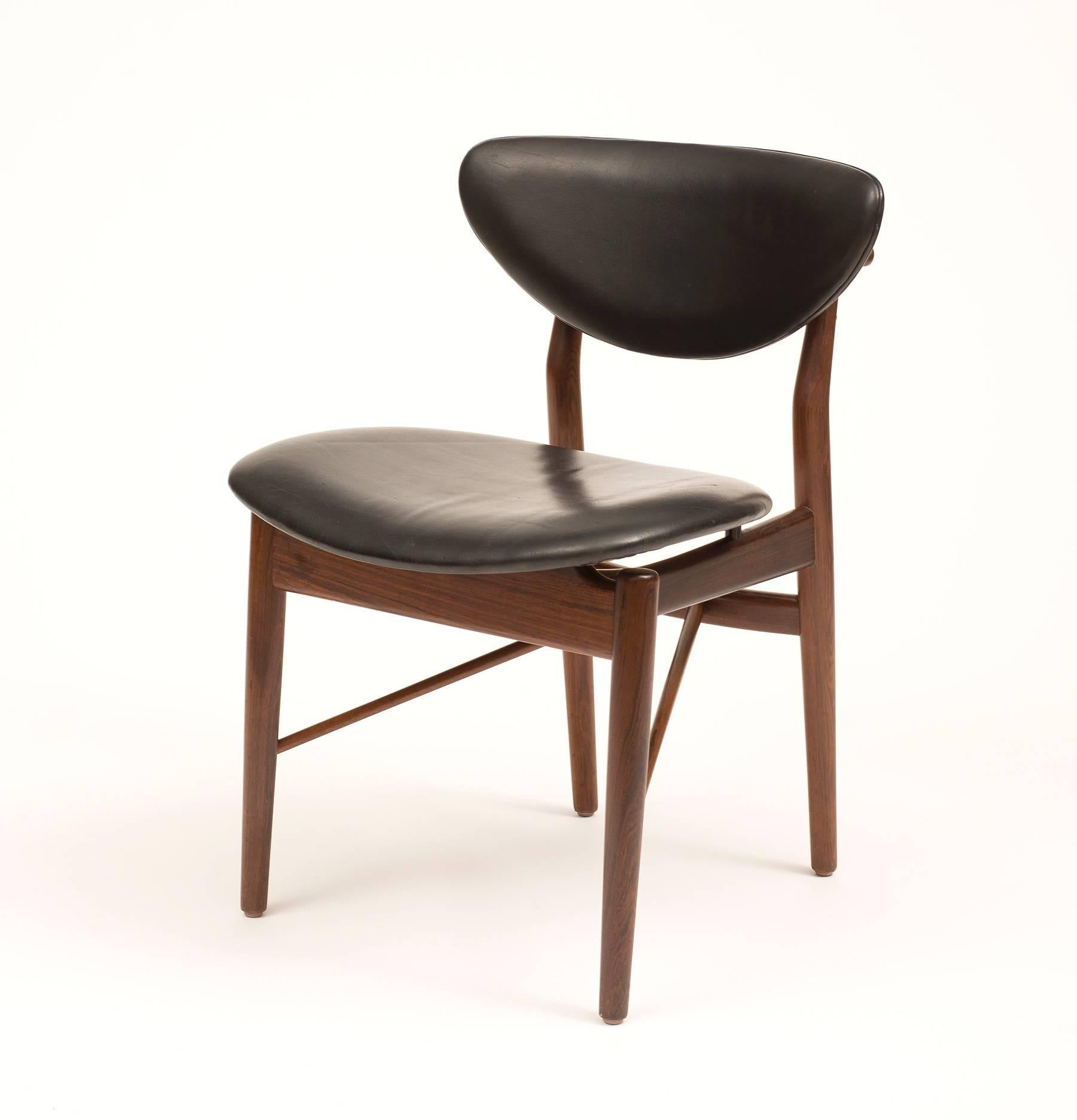 An rare, early set of dining chairs model NV55 in rosewood, designed in 1955 by Finn Juhl and produced by cabinetmaker Niels Vodder. These examples with original black leather.