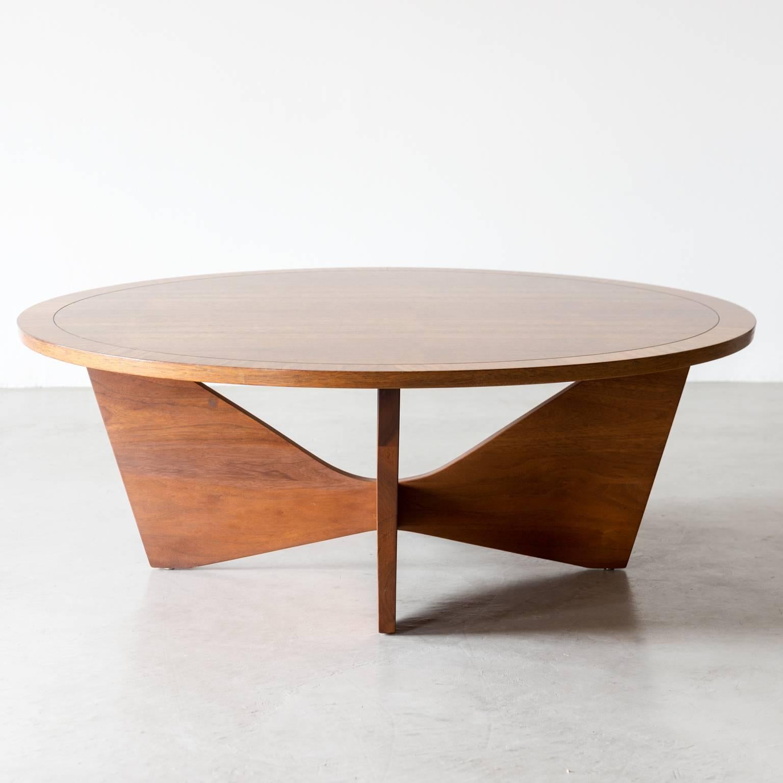 A rare round coffee table by George Nakashima, model 260-L, for Widdicomb, 1962. Branded with "George Nakashima", with Widdicomb label, stamped "Sundra". In laurel with solid walnut base.