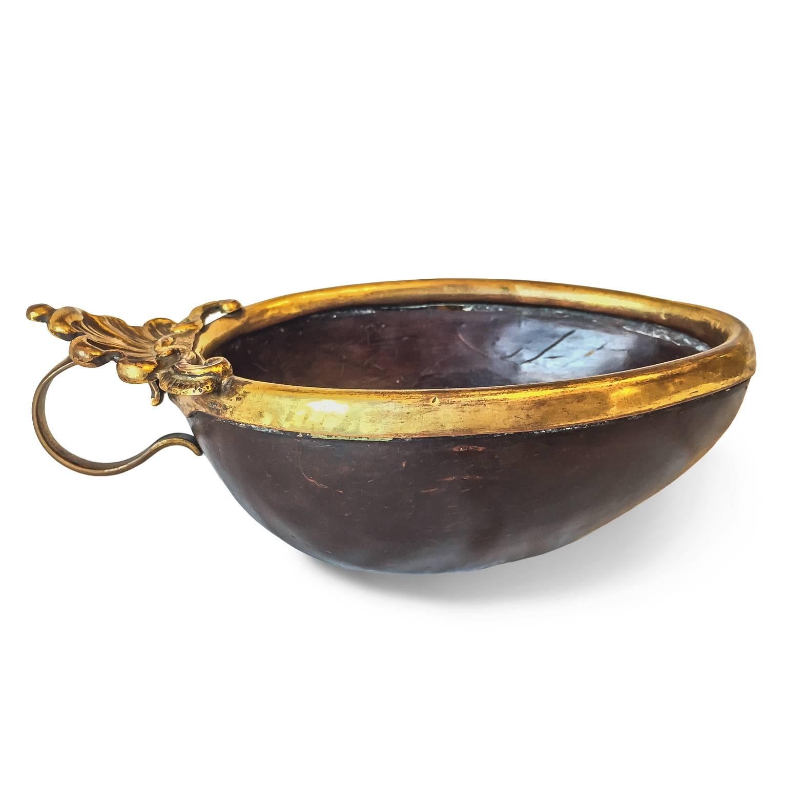 A very rare coconut cup, may be a liturgical baptismal bowl,  mounted on embossed and fire gilded copper with double scrolling handle. It is a very original work for connoisseurs and collectors only.
It comes from The Tuscany Granducato and dates