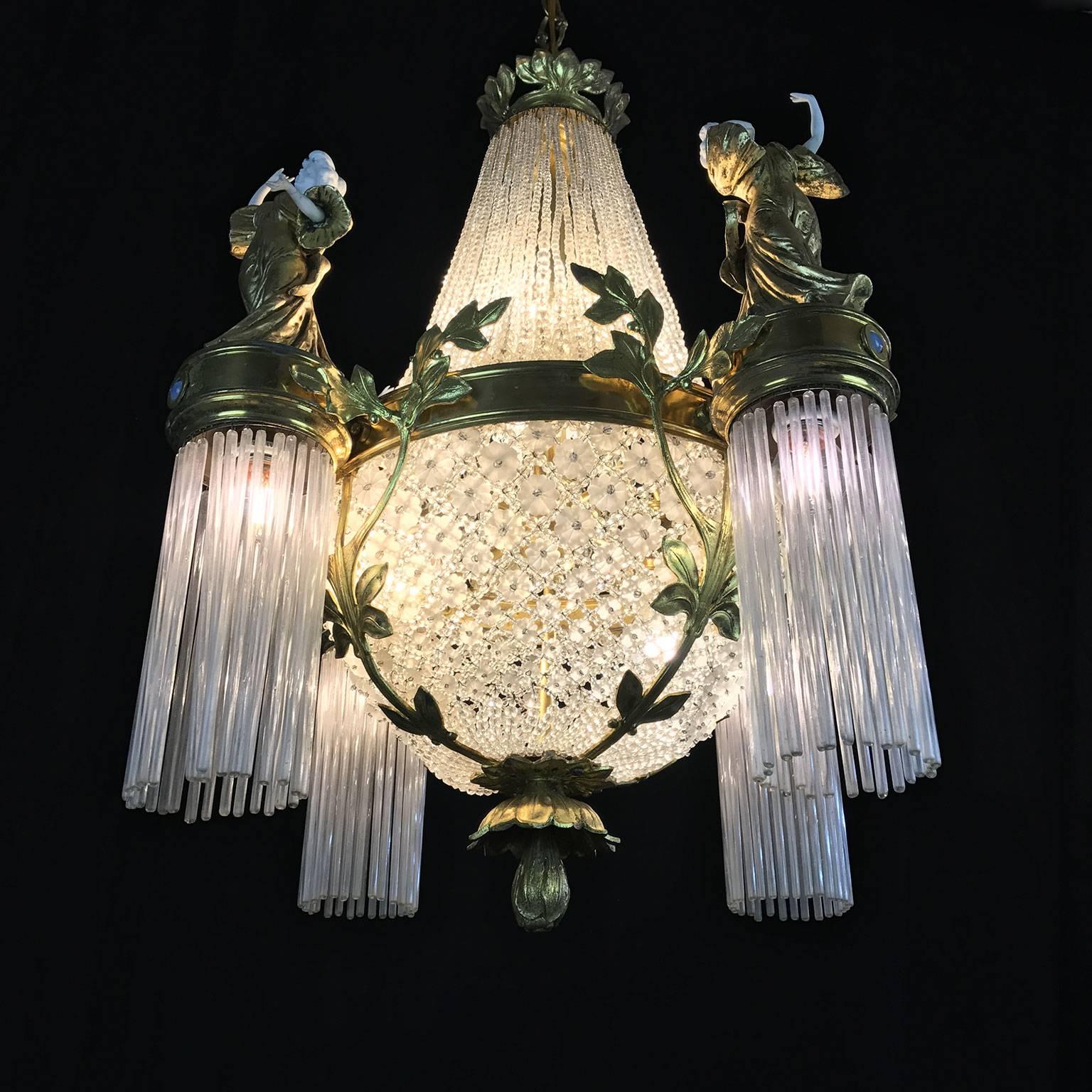 Exclusive French gilt bronze, crystal and porcelain figural eight-light chandelier dating back to circa 1910, in perfect condition.

This original French Art Nouveau chandelier, pendant has a unique circular cast bronze frame with very detailing