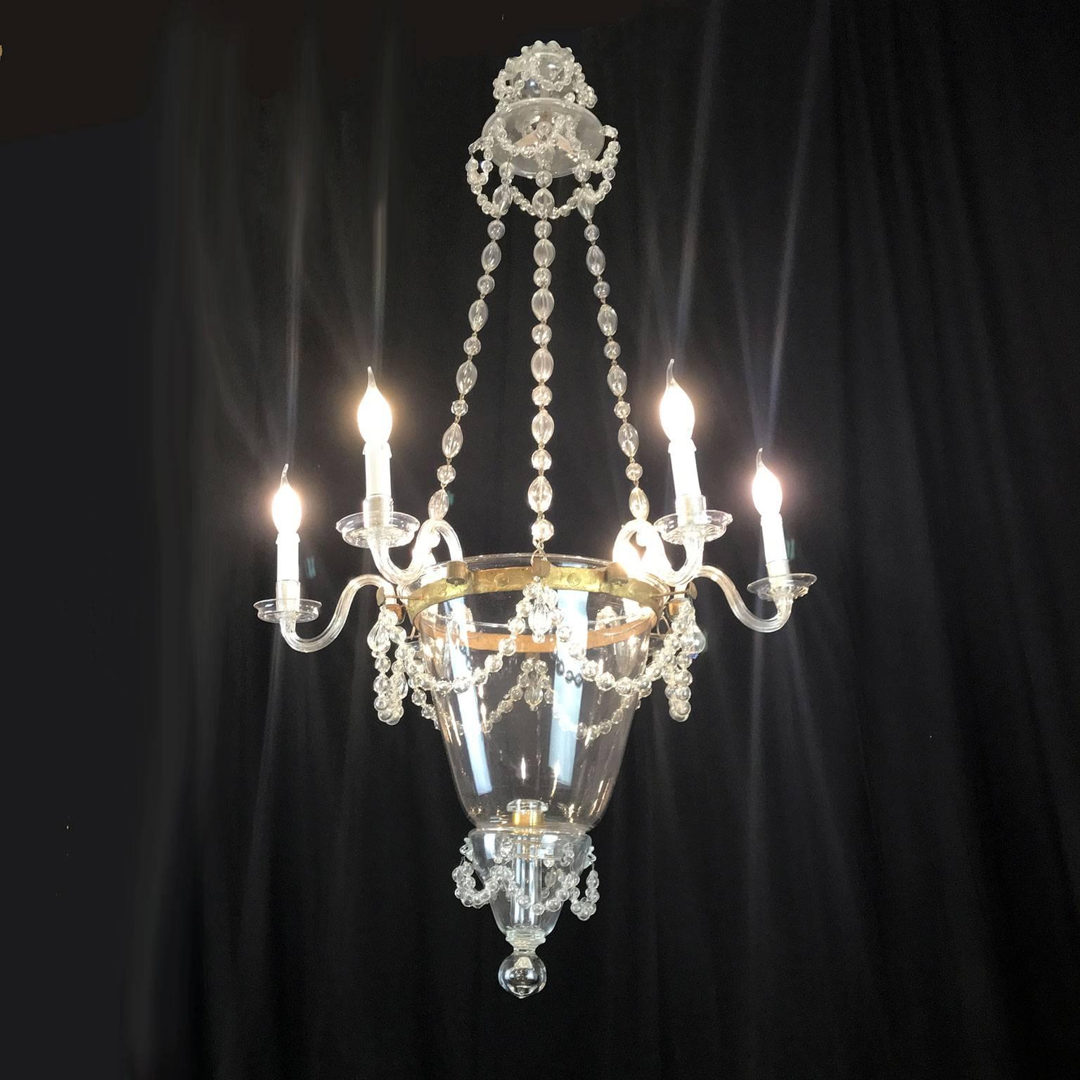 19th century Venetian Murano glass six-light chandelier, an antique clear blown glass chandelier with unconventional structure consisting of a circular gilt iron crown holding six curved arms and three oval blown glass beads chains.

Those chains