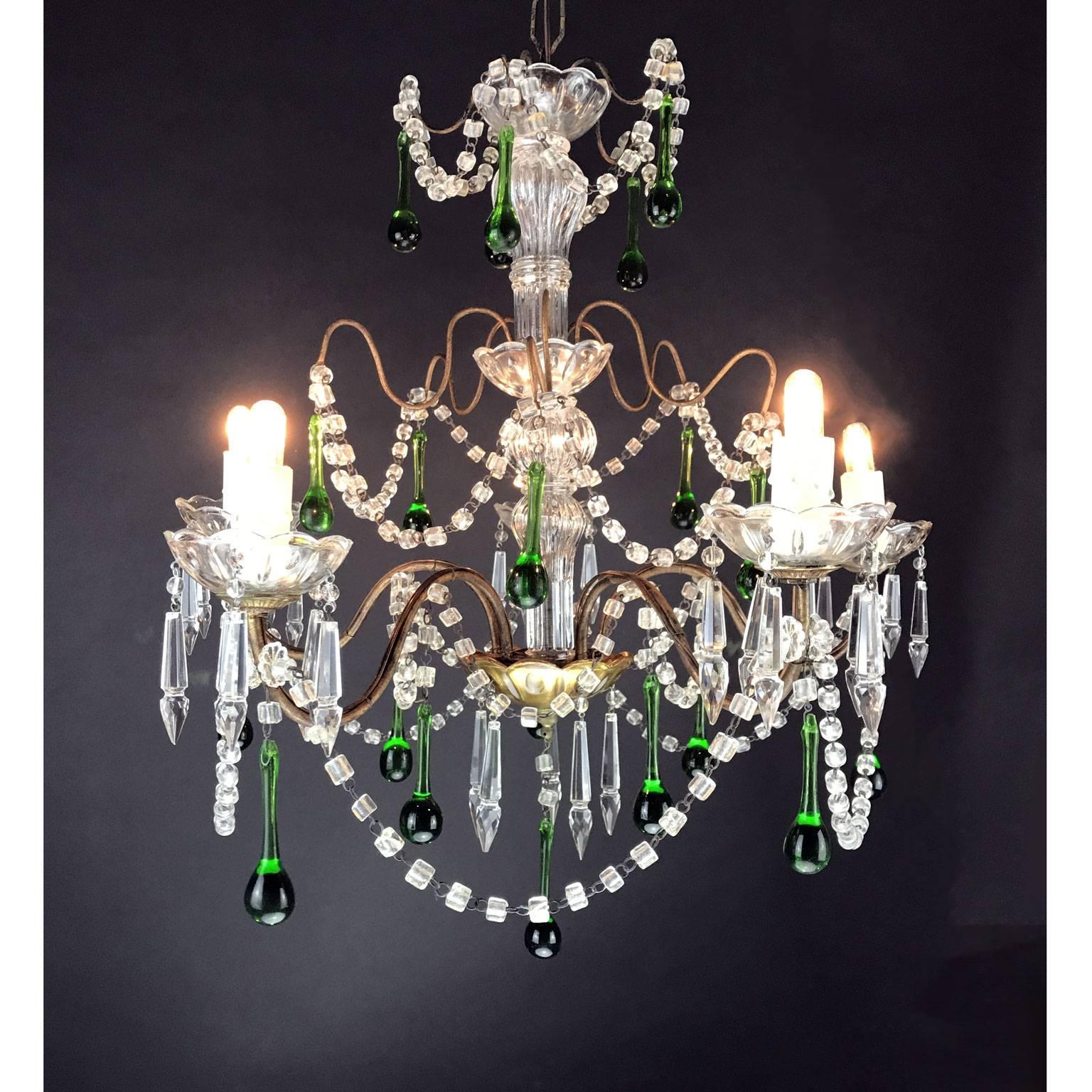 Italian five-light chandelier with a gilded brass frame with glass elements covering entire center support stem, five curved arms ending with etched glass bobeches, decorated with clear crystal beaded swags and green crystal drops. 
Good conditions,