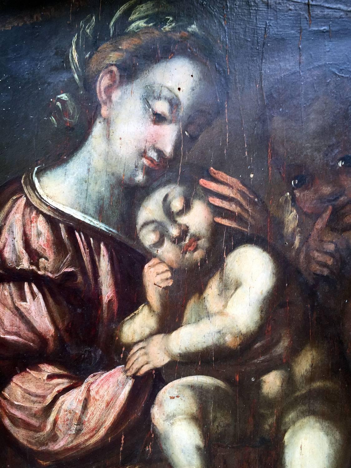 Italian oil painting on wooden panel depicting a Madonna with Child dating back to late 18th century. The painting is framed with a later carved wooden frame of early 1900, may be adapted. Lombard School, the Virgin is seated, the Child is sleeping.