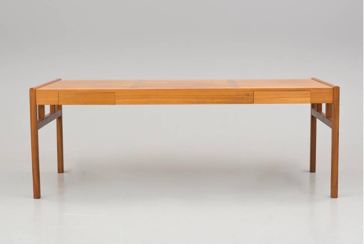 Sleek Mid-Century walnut and teak desk or a dining table with two drawers, circa 1970s.