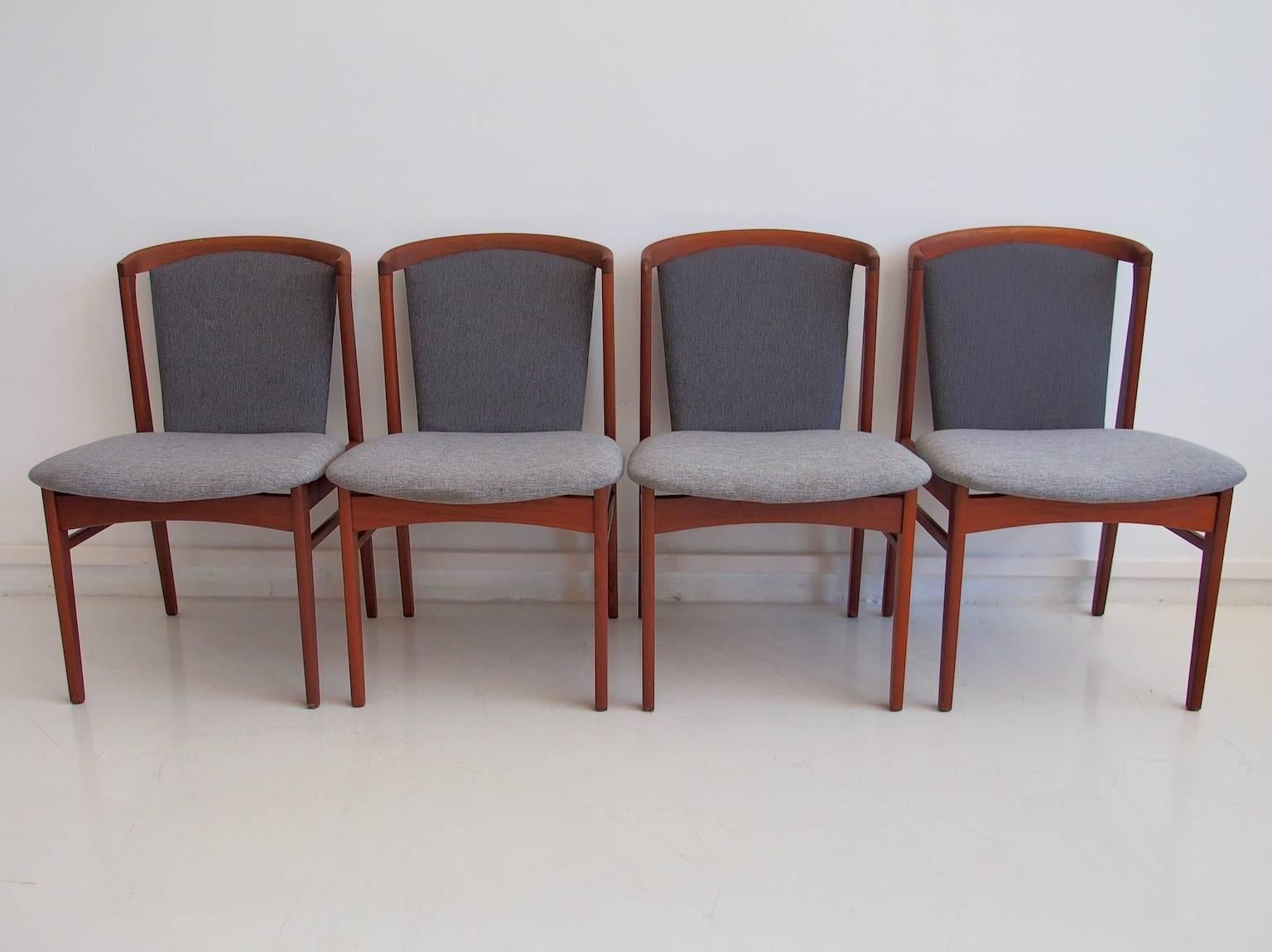Four teak dining chairs designed by Erik Buch for Christensens Møbelfabrik, Vamdrup. Four-legged teak frame construction, padded back and seat, with new cover melted in light blue and dark blue. Inclined backrest. Dimensions per chair: H. approx. 83