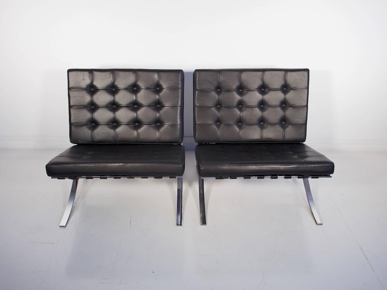 Pair of black leather Barcelona chairs by Ludwig Mies van der Rohe. These original Barcelona chairs feature a heavy chrome frame, but there are no markings or tags. They are a high quality pair of chairs in excellent condition. Cushions have been