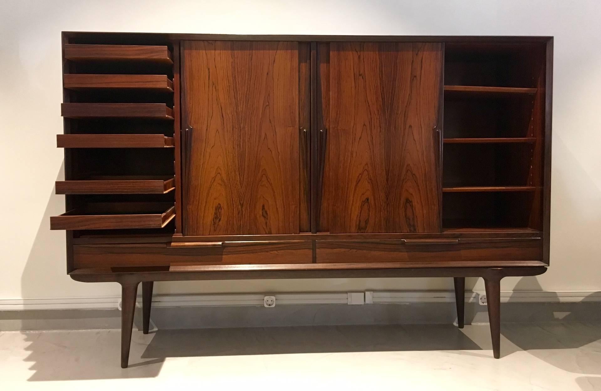 Beautiful rosewood cabinet, model 13, manufactured by Omann Jun Møbelfabrik. Four sliding doors and two drawers. Behind the right door are six felt-lined pull-out trays. Very good condition.