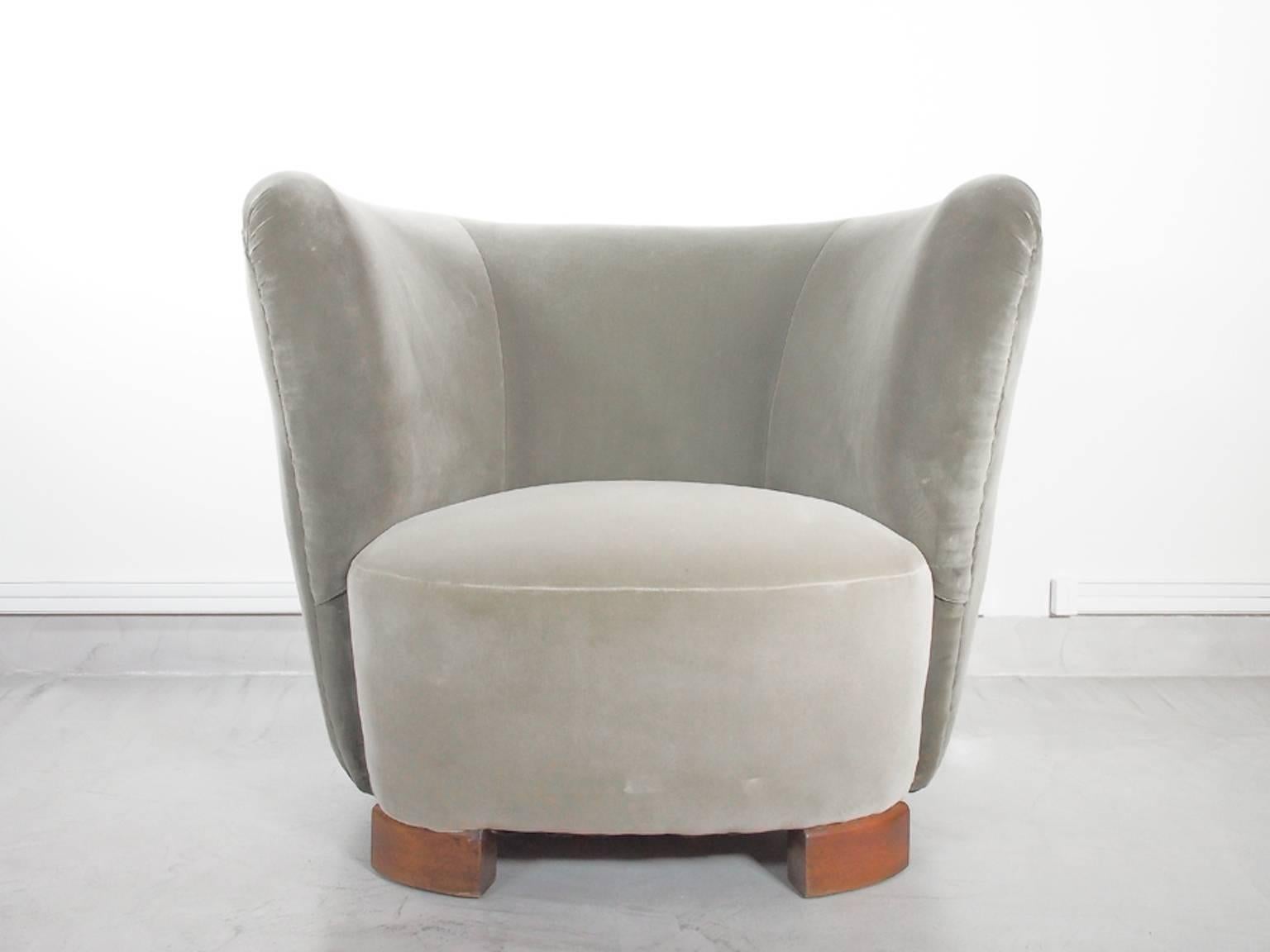 Beautiful velvet armchair in the style of Art Deco. Presumably Danish. Reupholstered in two different shades of grey velvet. Seat with springs, stained beech legs. Excellent condition.