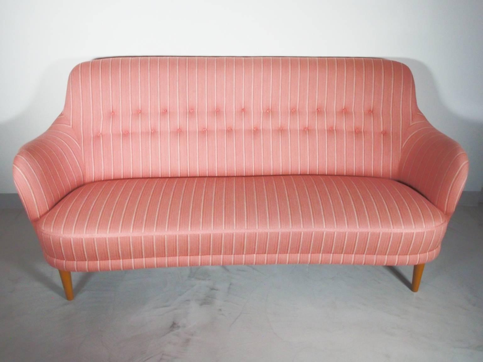 This three-seat "Samsas" sofa by Carl Malmsten is manufactured by O.H Sjogren in Sweden during the 1960s. It was originally designed by Malmsten in 1923. Professionally cleaned original pink and white striped wool upholstery, stained beech