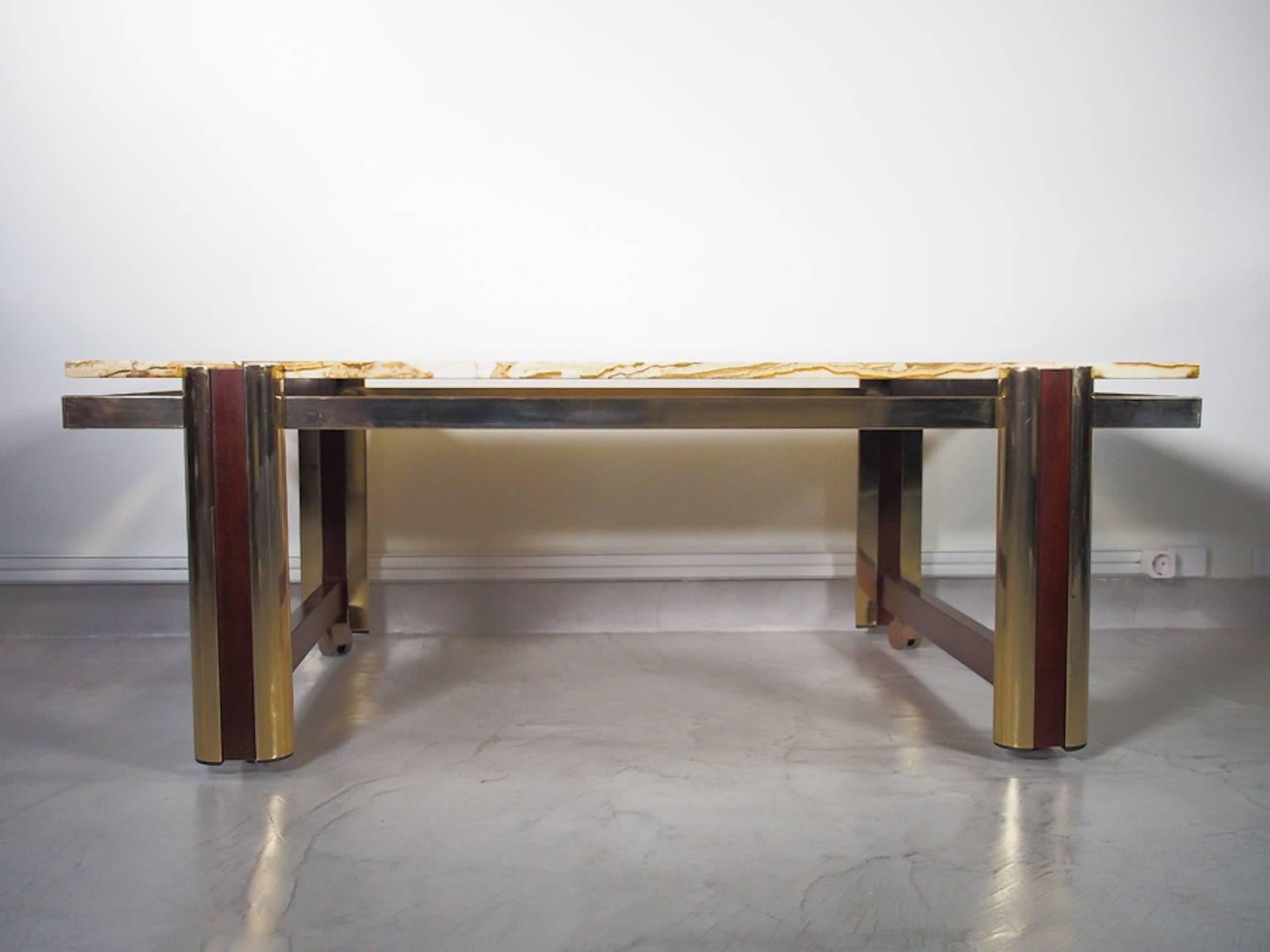 Large marble coffee table with brass frame and wooden details. Removable wheels to easily move the table around.
