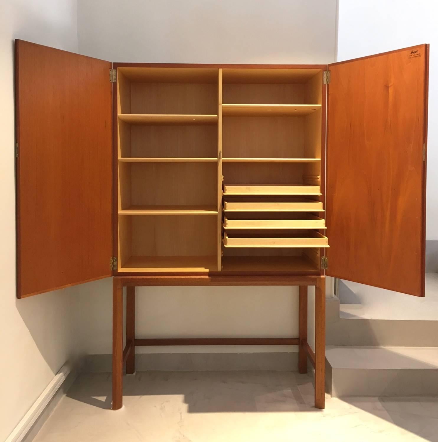 Rare teak cabinet designed by Axel Larsson for Bodafors, Sweden in 1961. Interior made of birch. Storage featuring shelves and pull-out trays. Ideal for a dining room. Recently restored very good condition, only minor darker stripe on one side. 