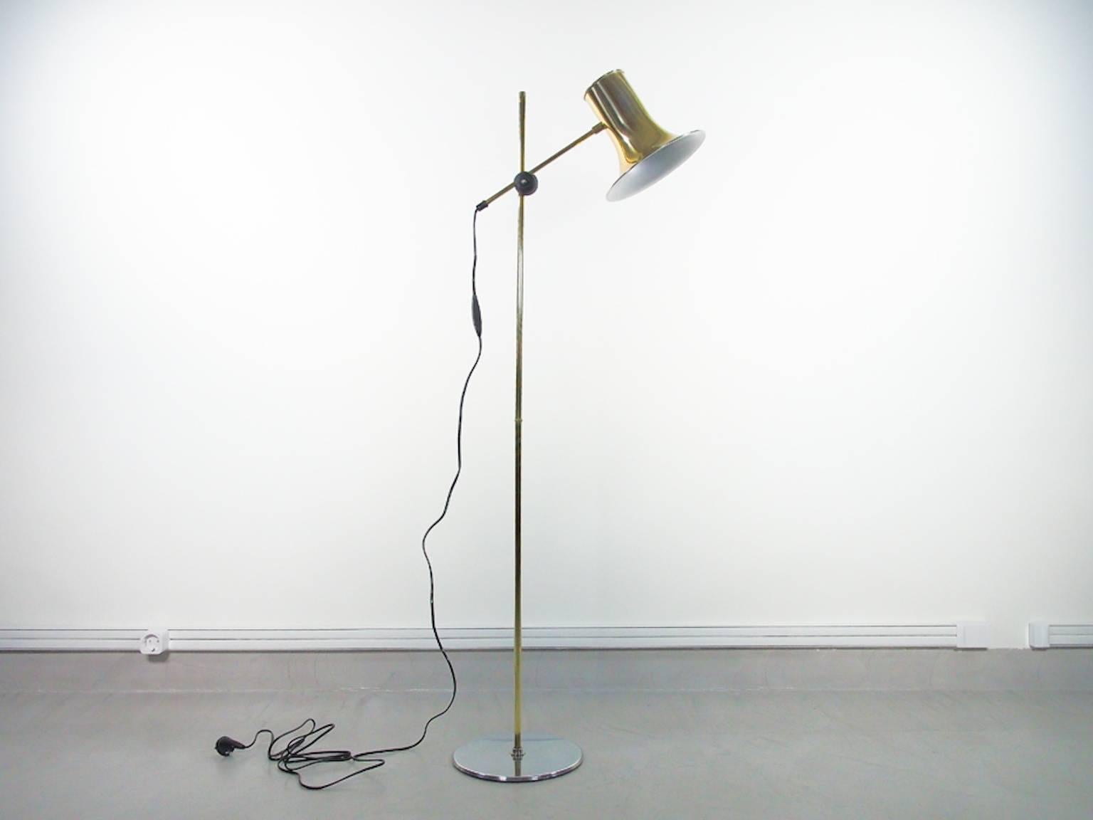 Swedish brass floor lamp manufactured by Hemi. Body made of brass, chrome circular base, adjustable shade.