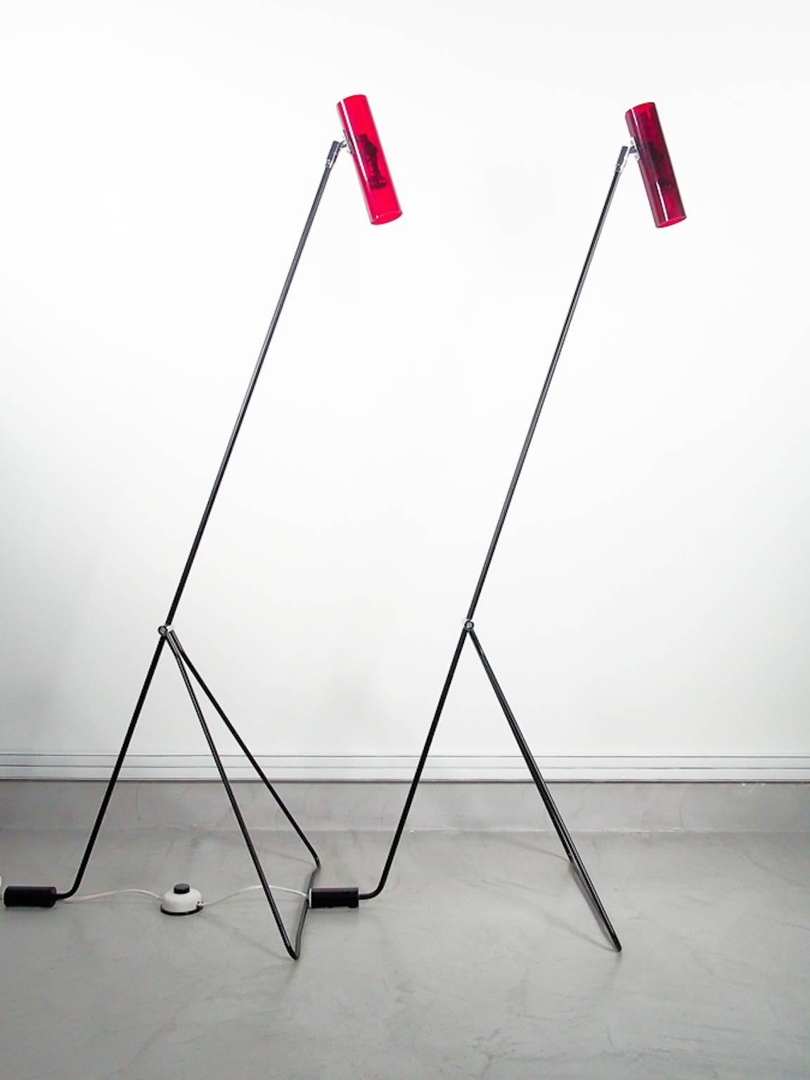 Two minimal style floor lamps with tubular steel frame and cylindrical lampshade in red Perspex. Design attributed to Alf Svensson, manufactured by Bergbom Scanlight AB in Sweden.