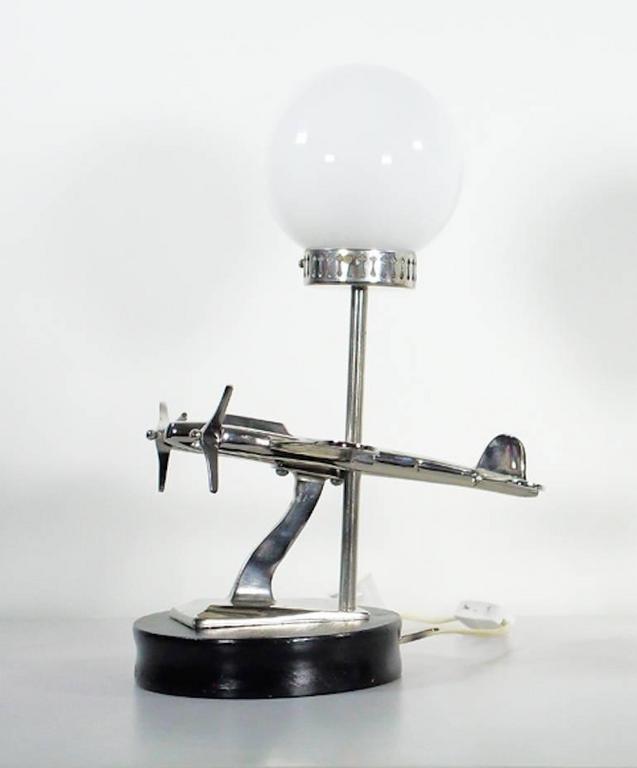 Art Deco Style Aircraft Shaped Chrome Table Lamp At 1stdibs Art Deco Style Table Lamp With An Airplane Shaped Decoration On A Black Wooden Base