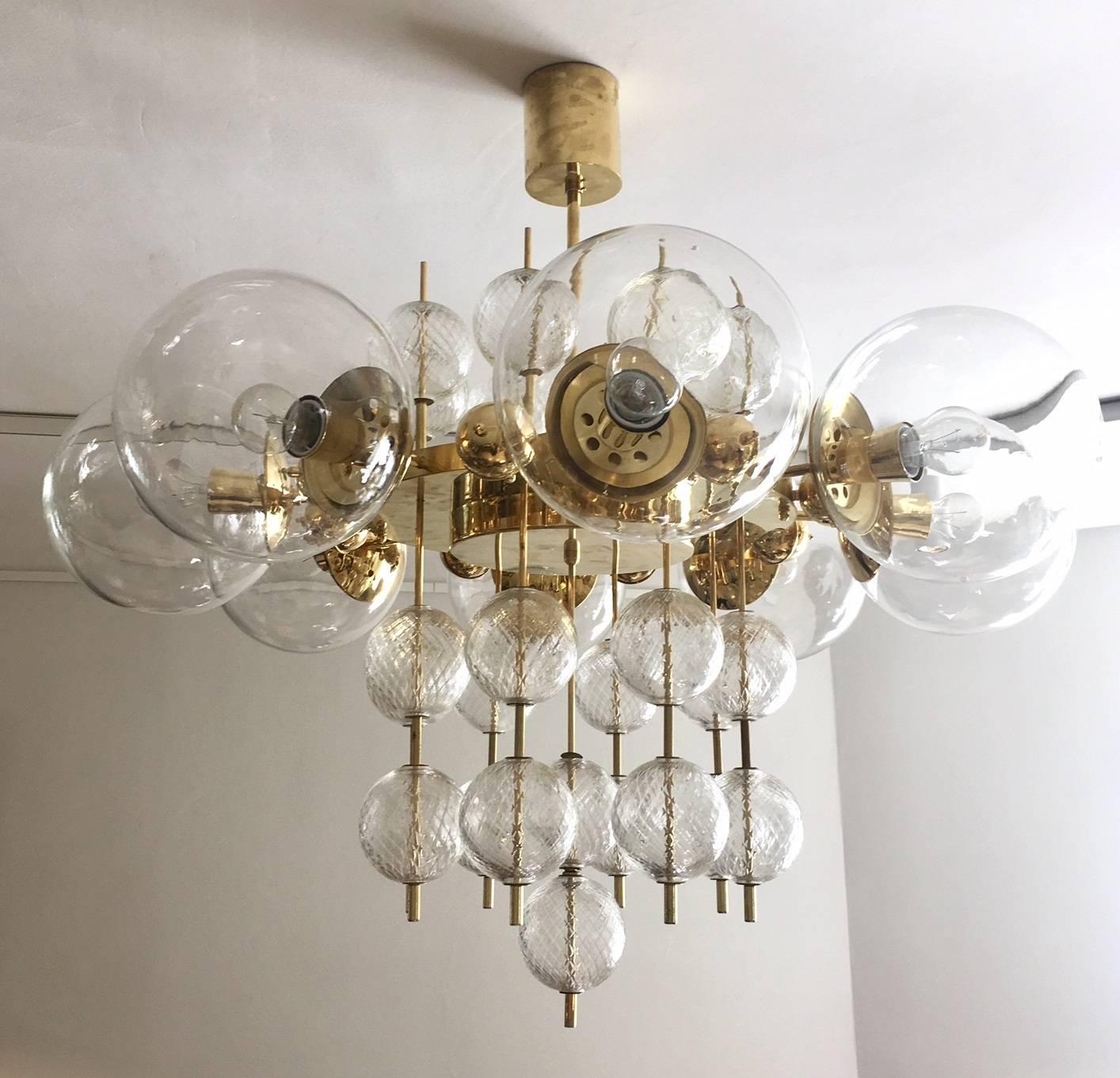 Gorgeous brass and handblown crystal chandelier with thirty five globes manufactured in Kamenicky Senov, Czechoslovakia in the 1960s. Eight larger round globes with light bulbs and twenty seven smaller diamond-patterned glass globes, brass structure.