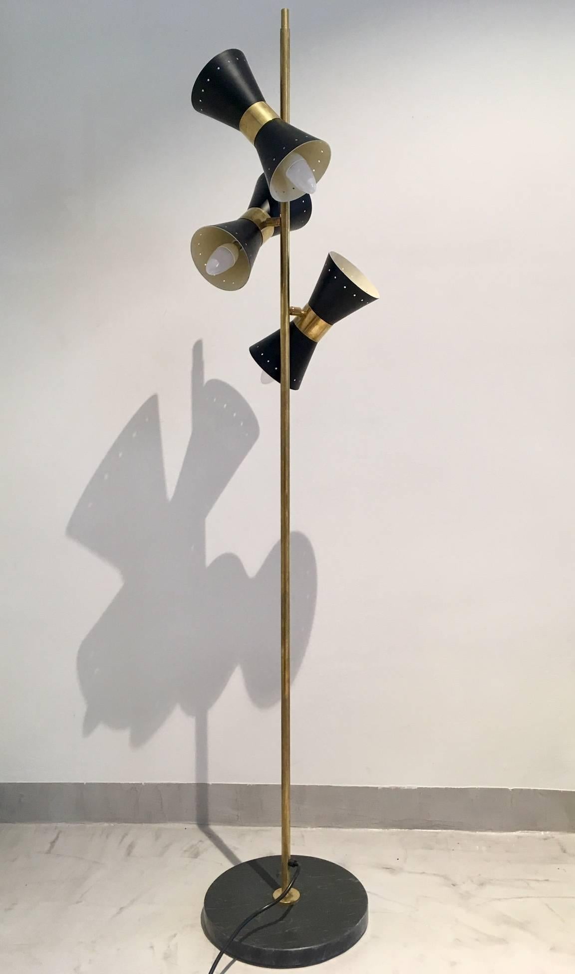 Brass floor lamp with three adjustable black metal shades and marble foot. Black-varnished metal shades, six-light sockets. The shades have been re-varnished. Minor age-related scratches and stains on brass.