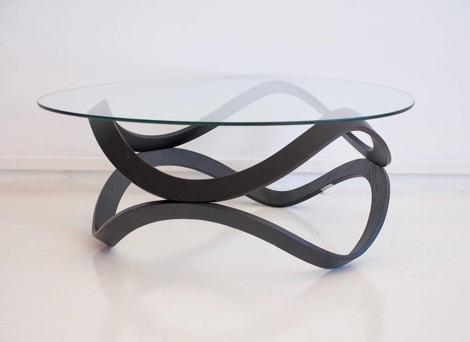 Beautiful NEWTON shaped table which formed derives from the nature of the two rings which converge towards the center. This coffee table won the Nordic Design Prize in 2009 and Elle Interior Design Award 2010.
