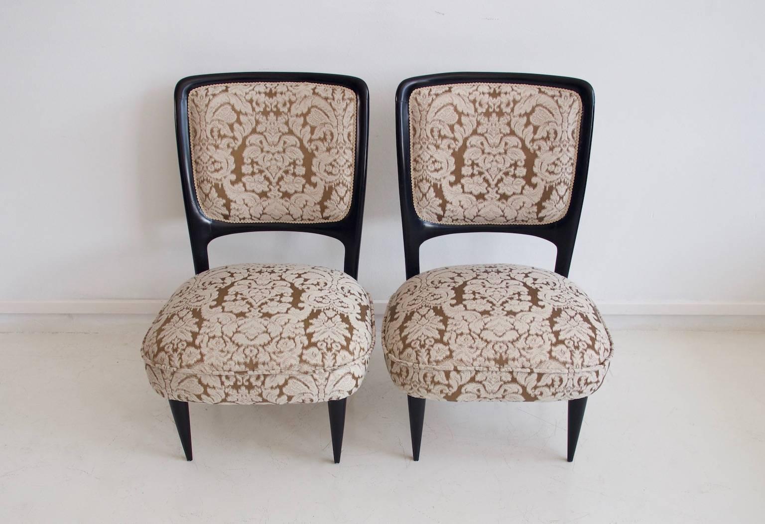 Pair of Italian chairs from circa 1950s. Frame of mahogany wood, renewed padded seats and back. The chairs are handmade and the dimensions of each of them are slightly different for that reason. The dimensions of the small chair are 60 cm depth x 59
