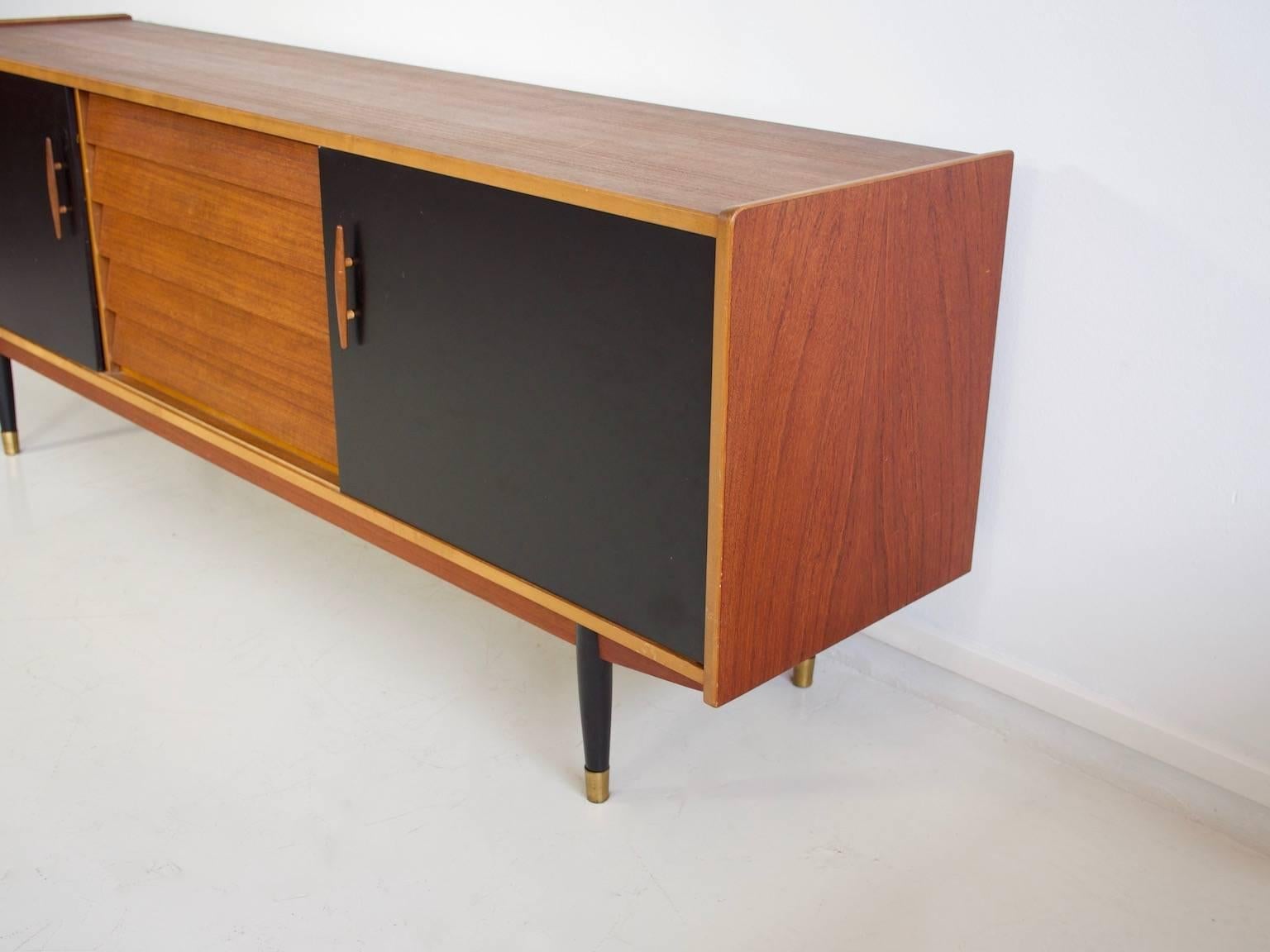 20th Century Long Teak Sideboard with Drawers and Black Sliding Doors by Hugo Troeds