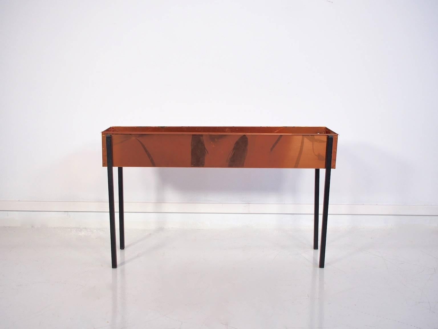 A Mid-Century flower table, Jardinière by a Scandinavian maker. Copper sides with metal legs in black.