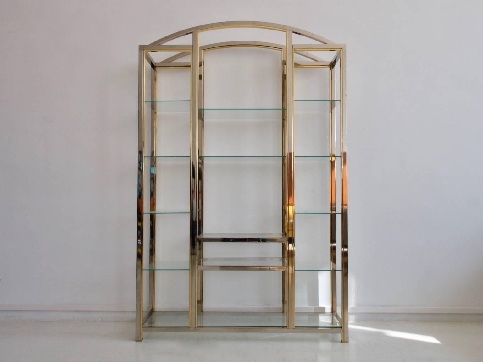 Large shelf of the 1970s-1980s in the style of Romeo Rega / Maison Jansen. Chromed and gold metal construction with glass shelves.