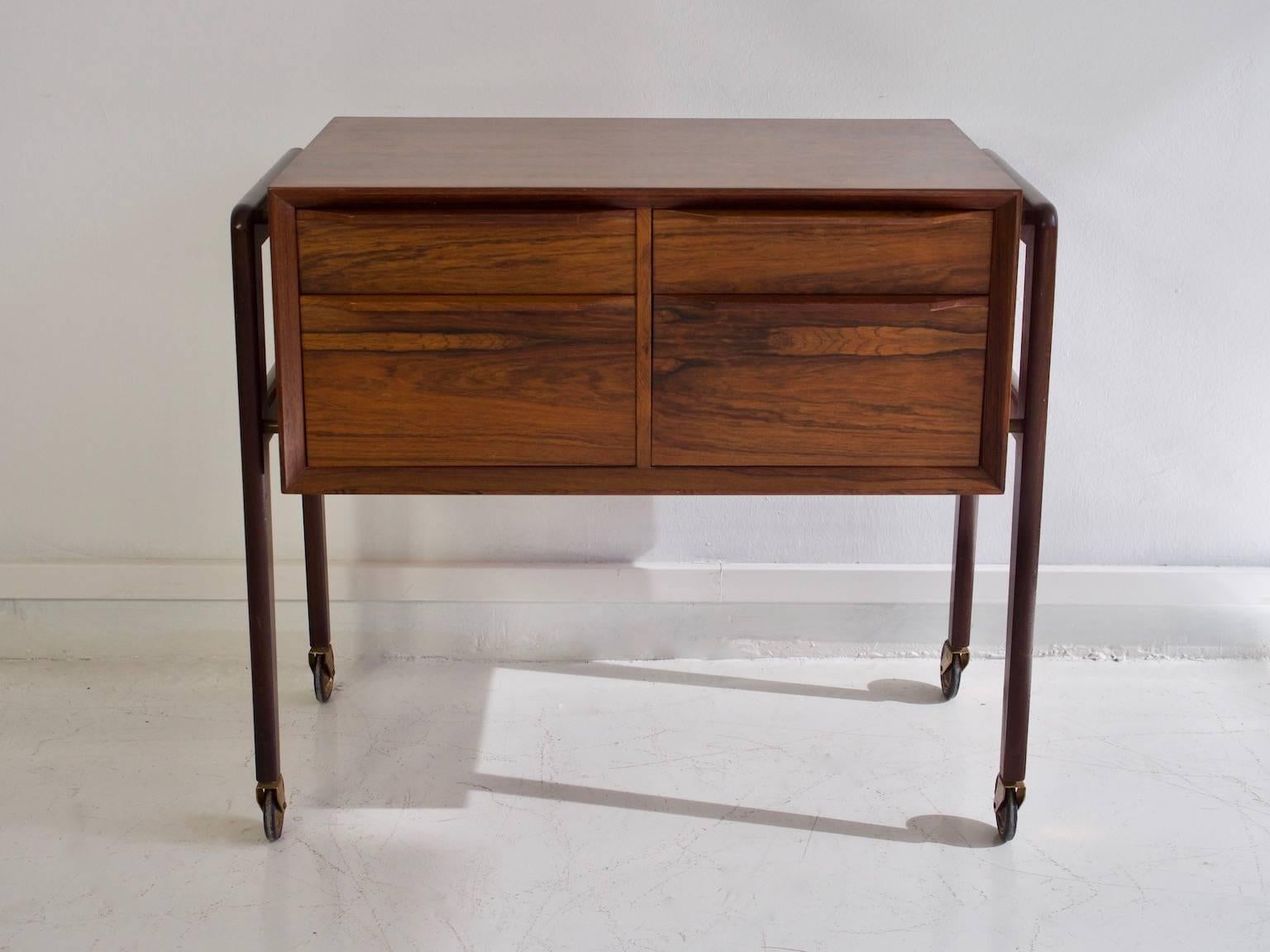 Rosewood commode, chest of drawers or sewing table. Front with four drawers, brass details. Measures: H 62, B 70, D 40 cm.