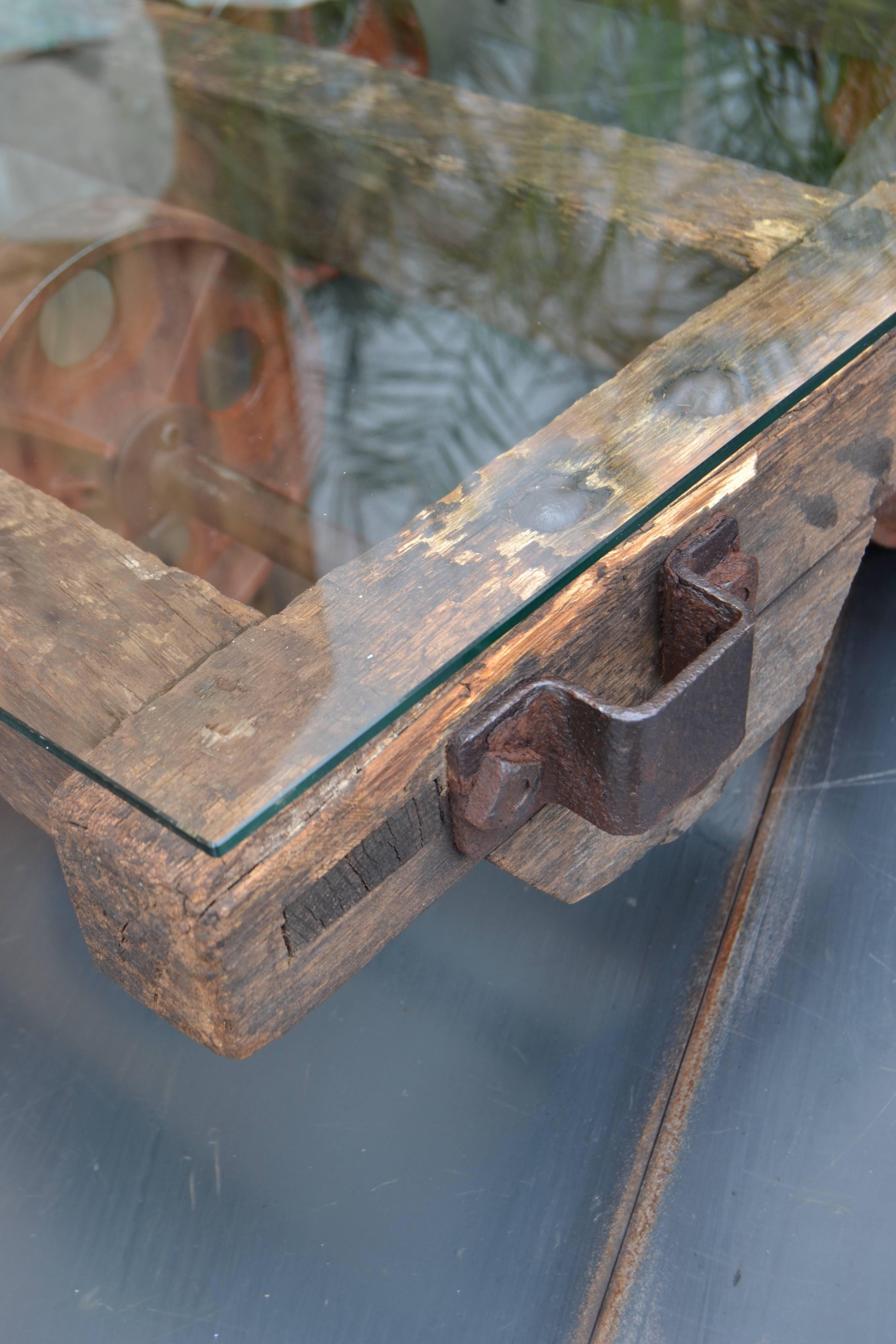 Coffee table, old wagon of French coal mine
structure is wood
glass top security,
circa 1930.